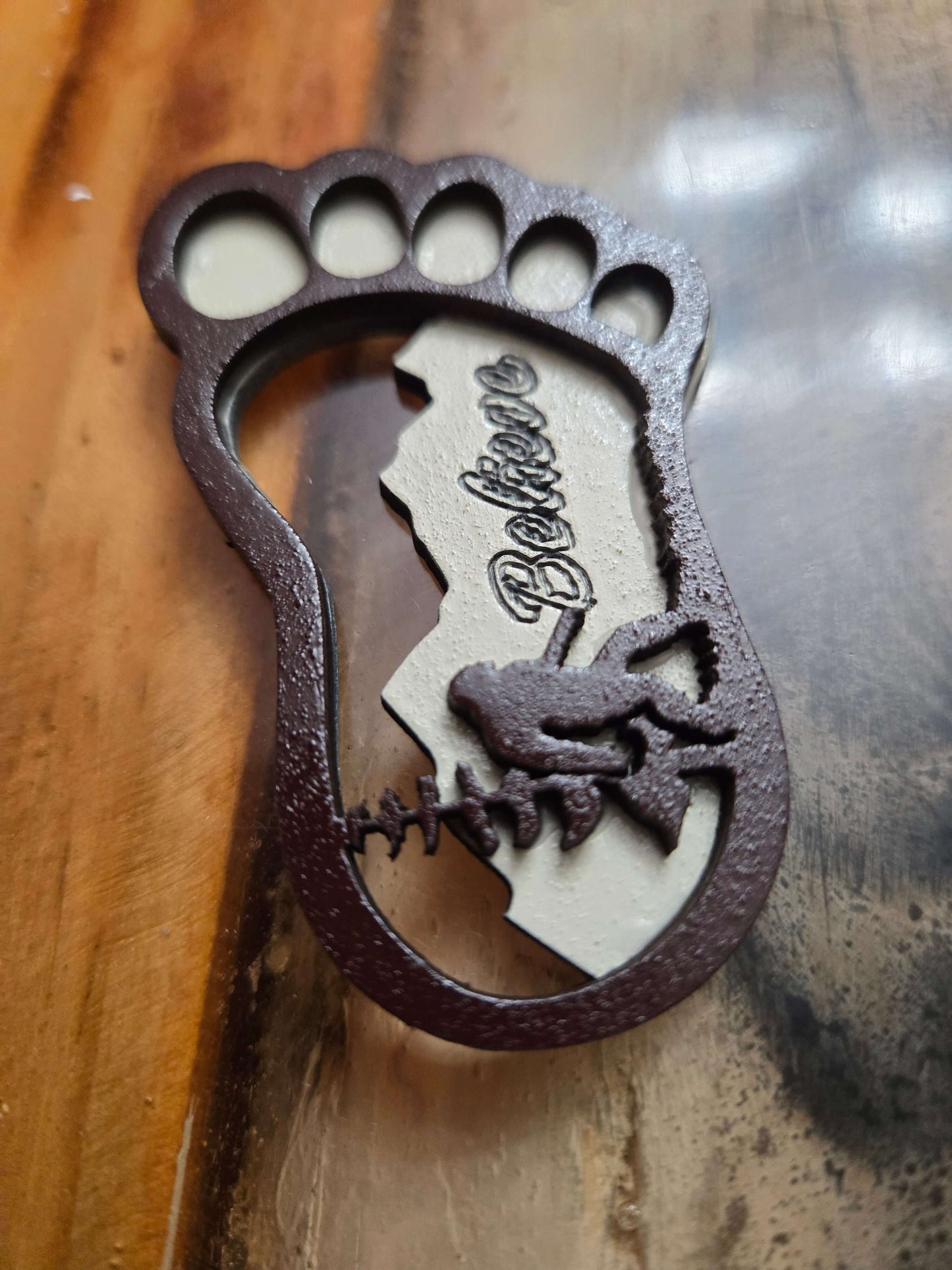 Handcrafted Bigfoot keychain featuring a footprint design with 'Believe' text, perfect for organizing on the go.