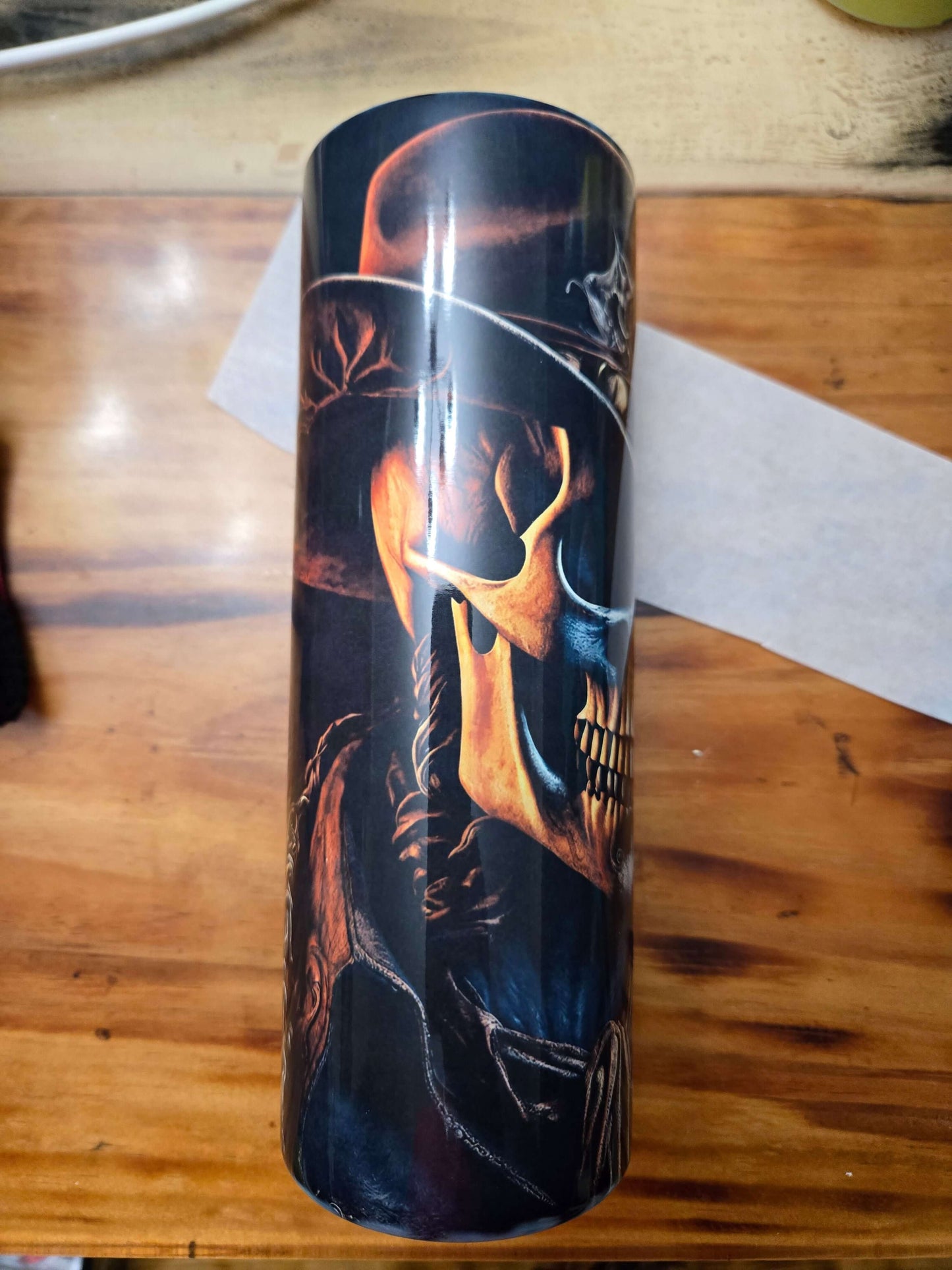 Skull cowboy design tumbler cup showcasing intricate details, perfect for hot and cold beverages on the go.