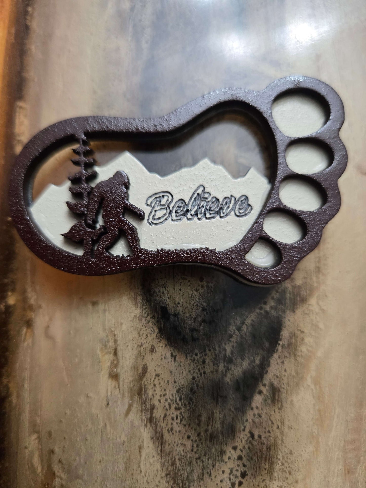 Bigfoot keychain featuring a carved design with 'Believe', perfect for travel and organizing essentials.