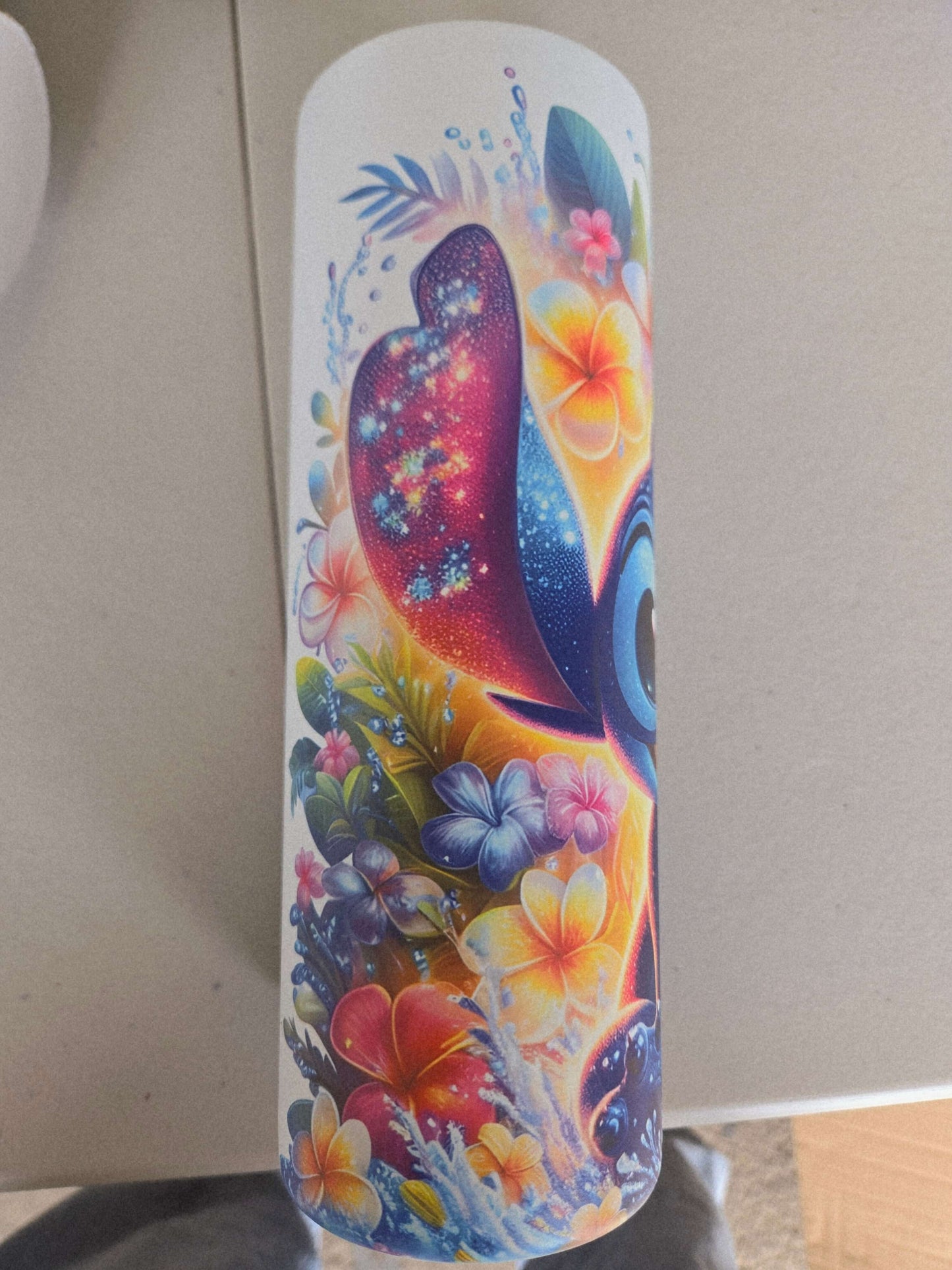 Vibrant Lilo and Stitch tropical tumbler featuring colorful flowers and a playful Stitch design.