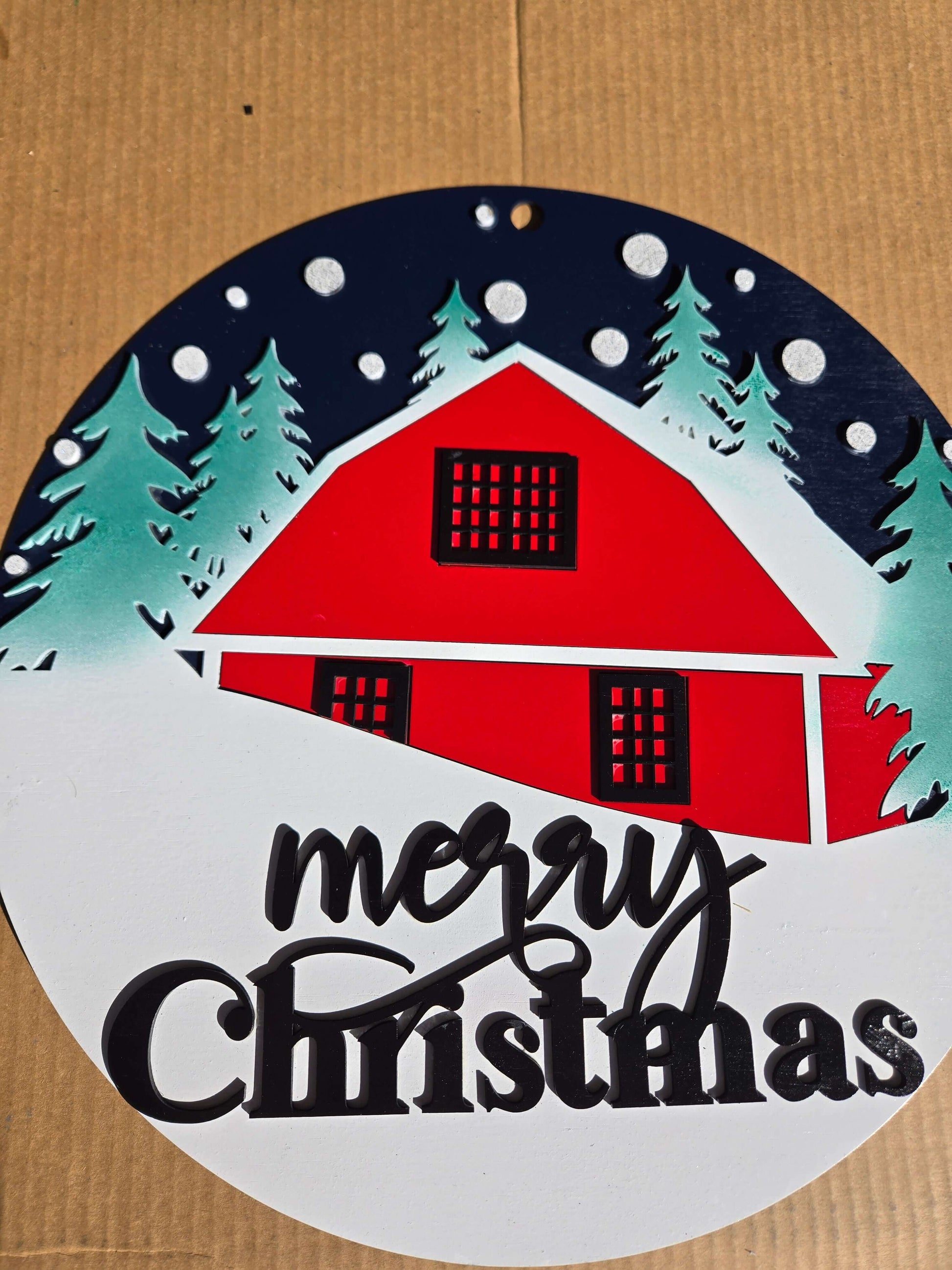 Merry Christmas wooden decor sign featuring a red cabin and snowy trees, perfect for festive home decoration.