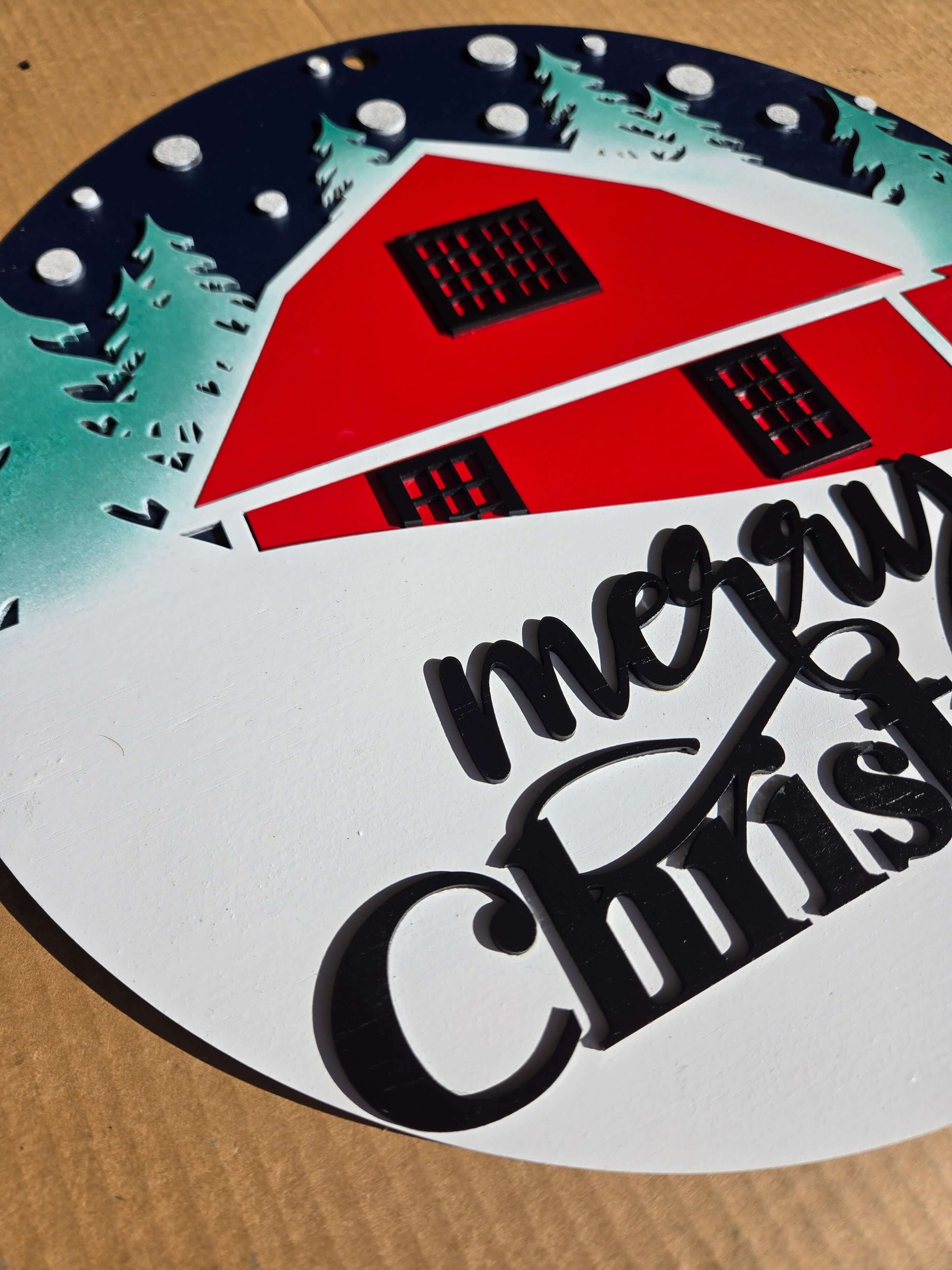 Merry Christmas wooden decor sign featuring a red cabin and snowy background, perfect for festive home decoration.