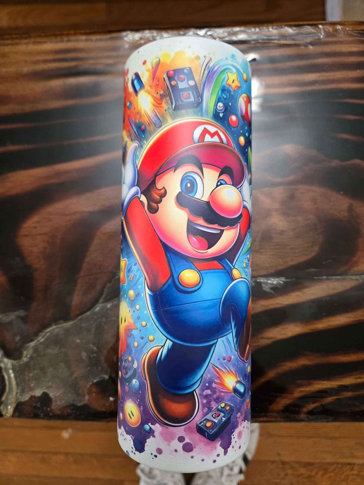 Vibrant Mario Brothers tumbler cup featuring Mario jumping with colorful graphics, ideal for kids and adults.