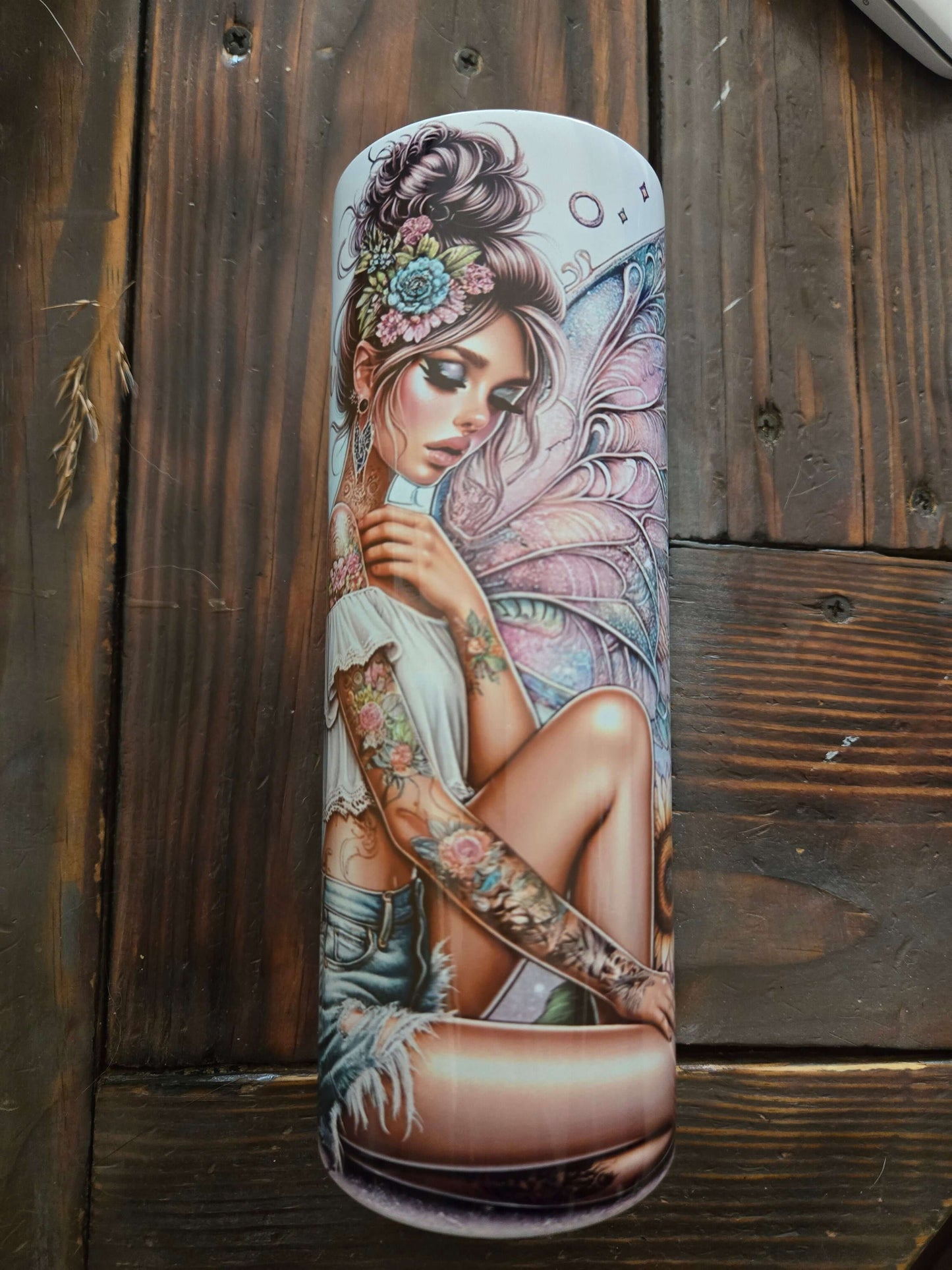 Artistic 20oz tumbler cup featuring a fairy design with tattoos and a floral headband, perfect for stylish drink lovers.