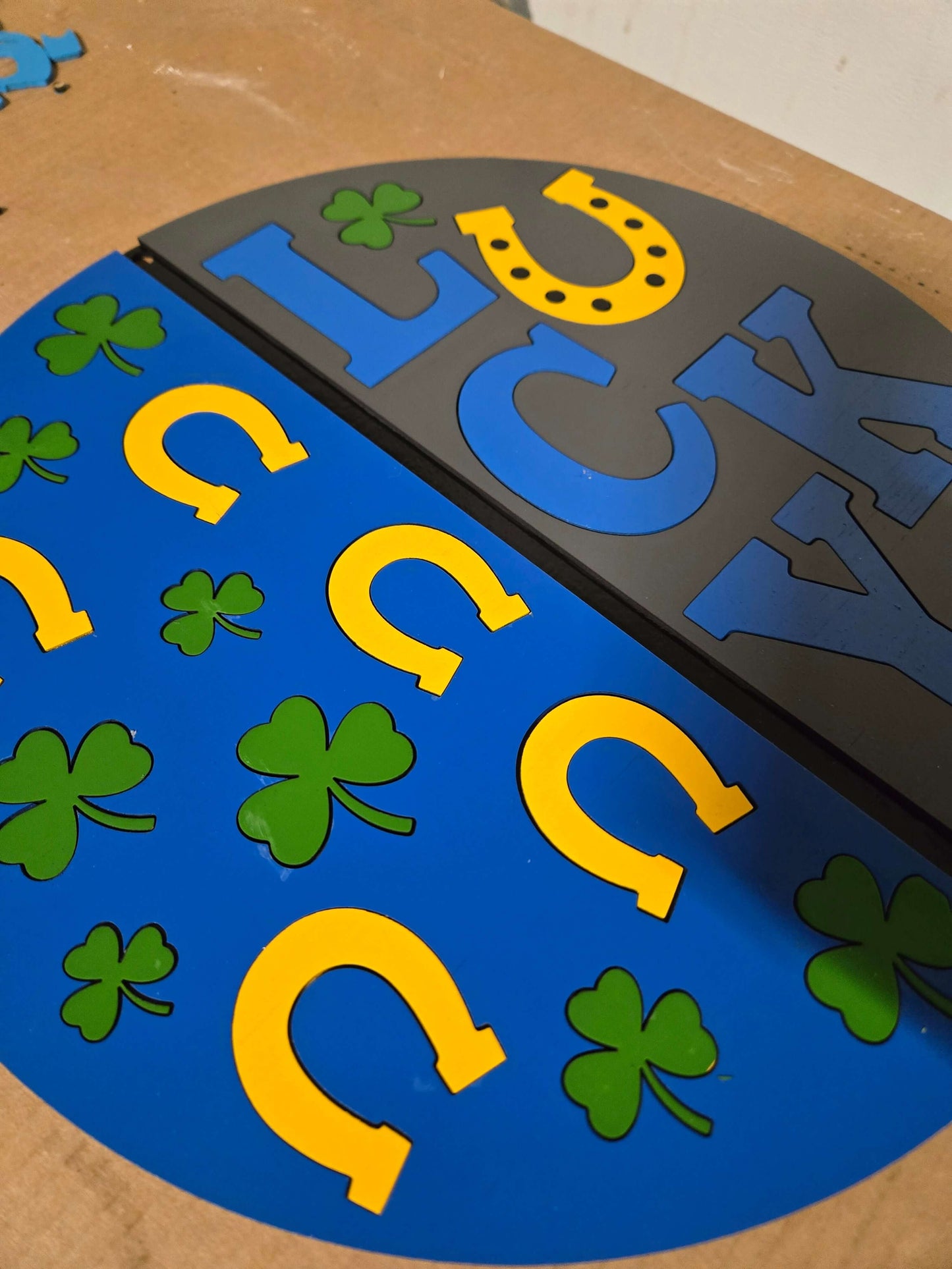 Lucky St. Patrick's Day wooden decor signs featuring colorful clovers and horseshoes.
