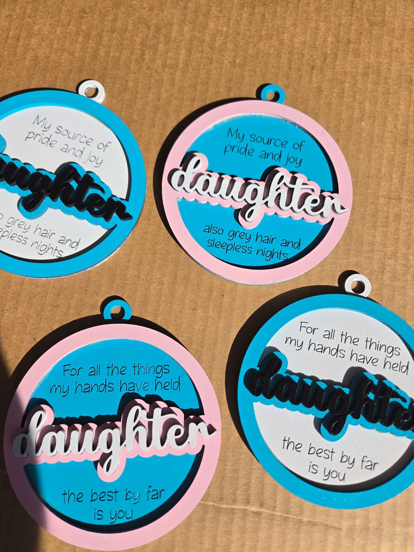 Daughter quoted Christmas ornaments featuring heartfelt messages and colorful designs for holiday decor.