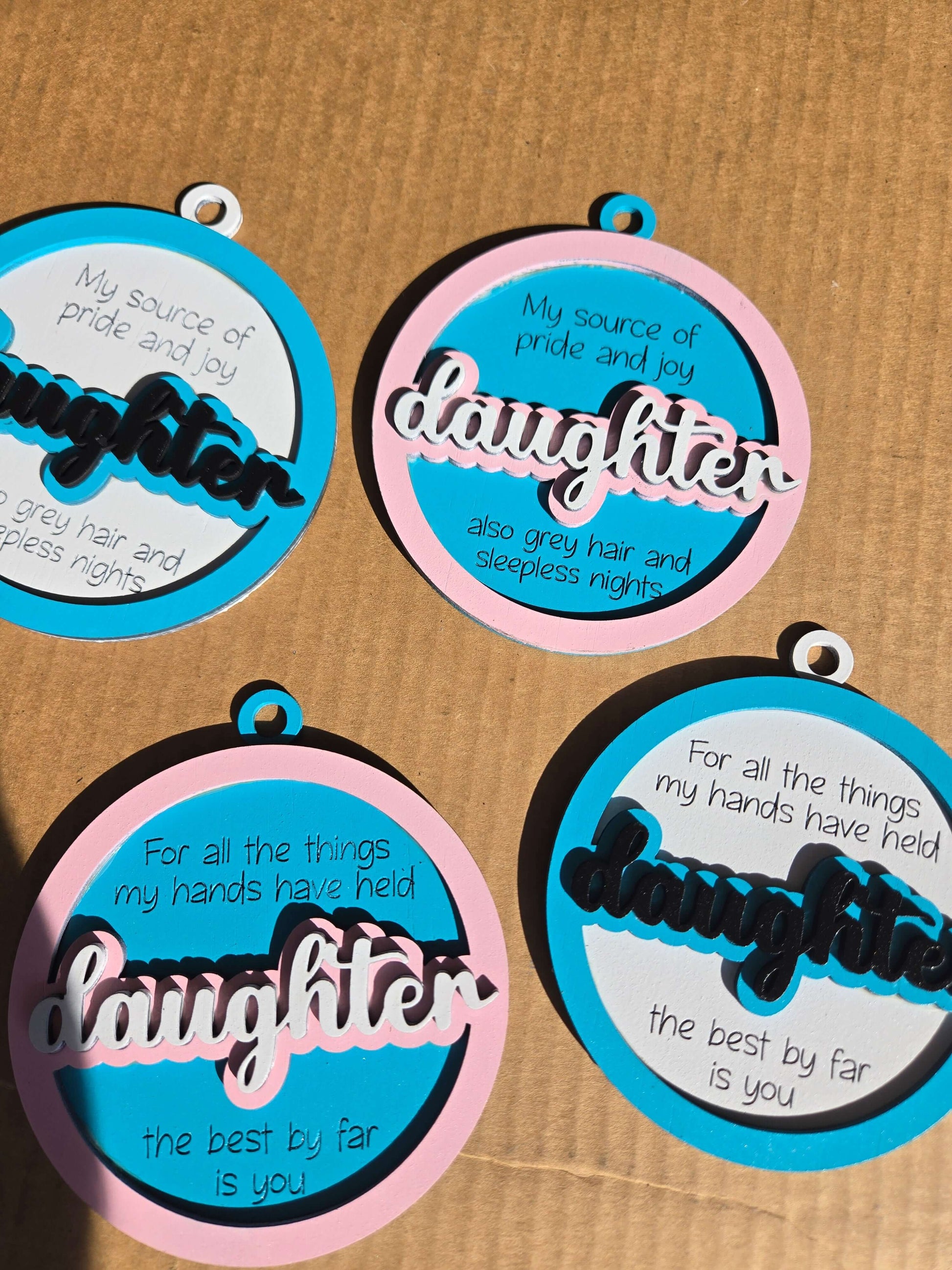 Daughter quoted Christmas ornaments featuring heartfelt messages and colorful designs for holiday decor.