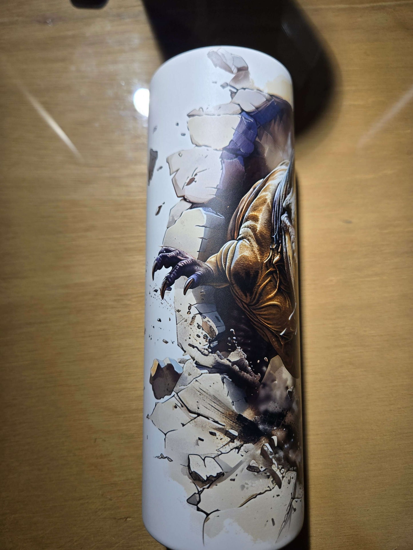 T Rex glow in the dark tumbler cup featuring dynamic dinosaur design breaking through a cracked surface.