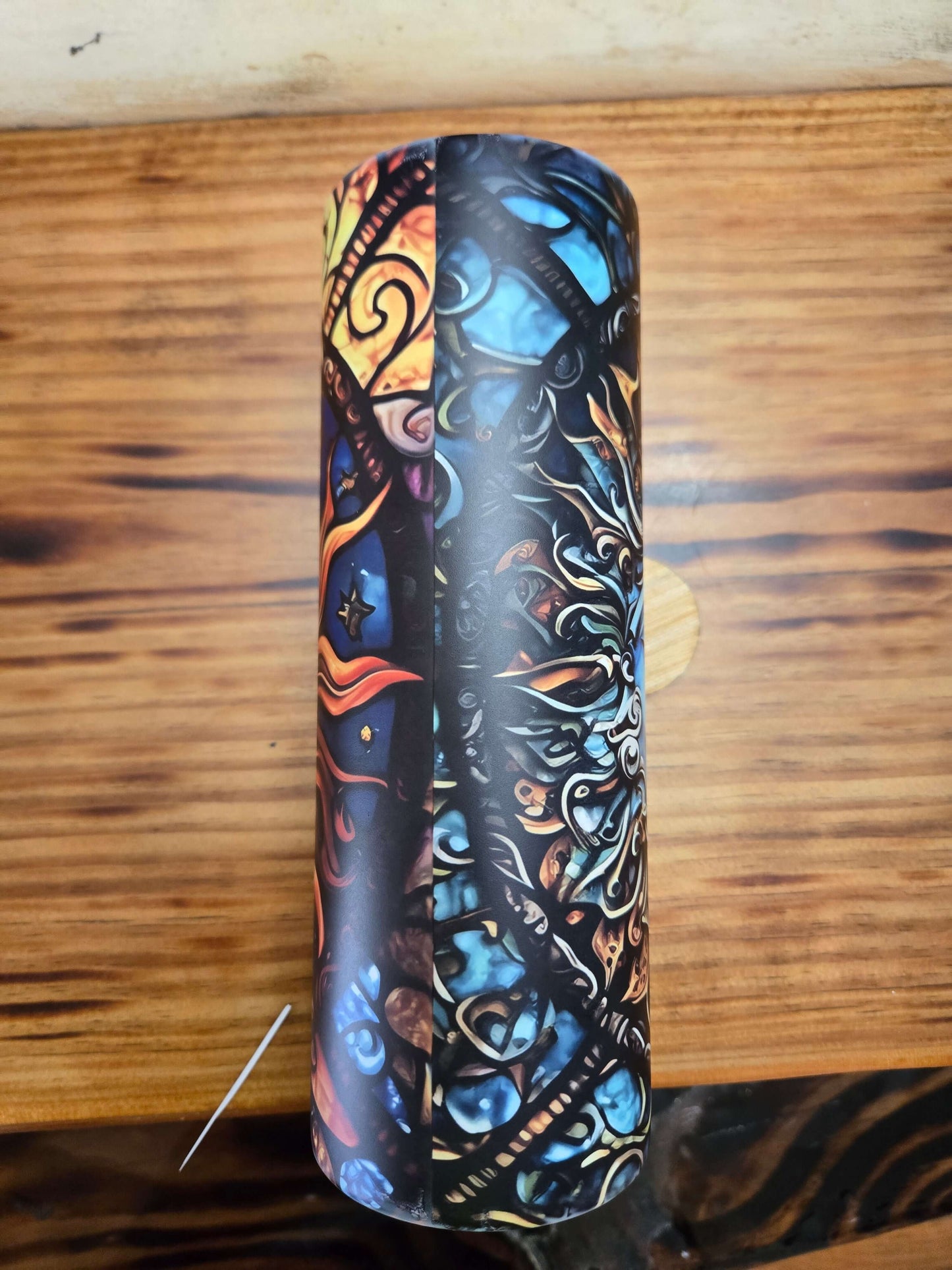 Colorful sun and moon tumbler cup showcasing vibrant designs and artistic patterns.