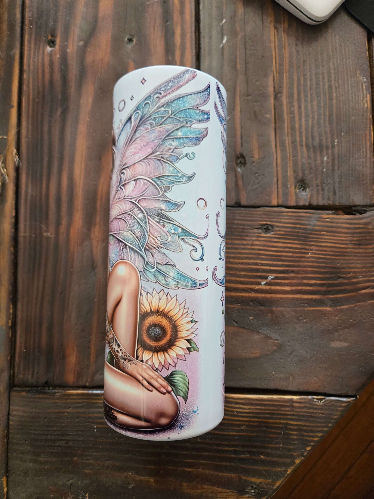 Colorful tumbler featuring a fairy girl design with sunflowers, perfect for stylish beverage enjoyment.