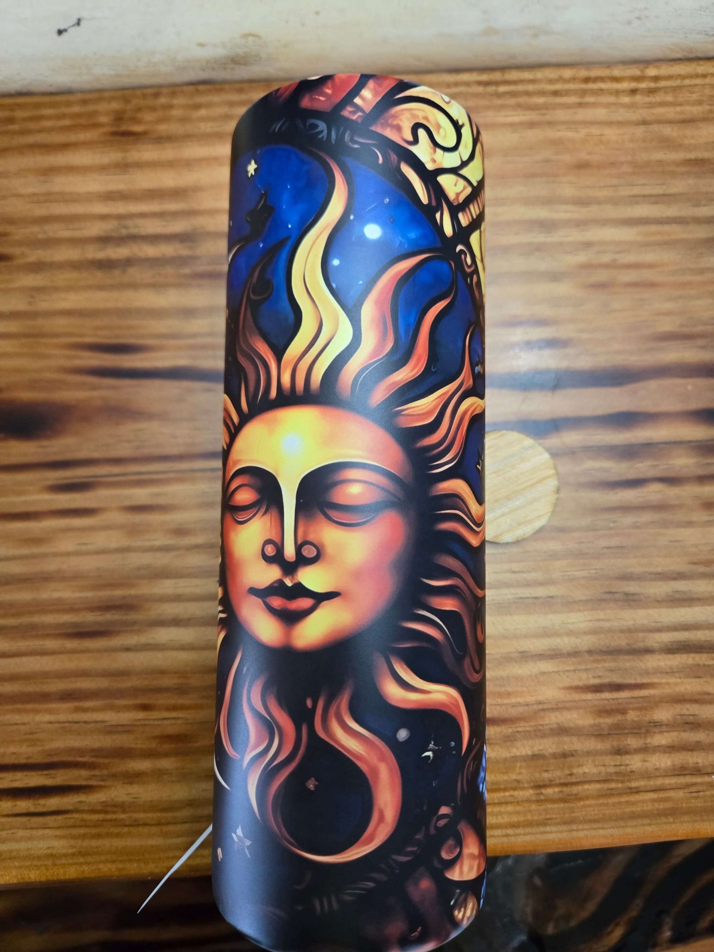 Sun and moon tumbler cup featuring a vibrant sun design against a starry night background.