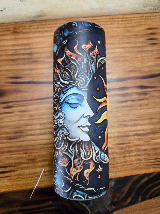 Sun and moon tumbler cup featuring an artistic design of celestial faces on a black background.