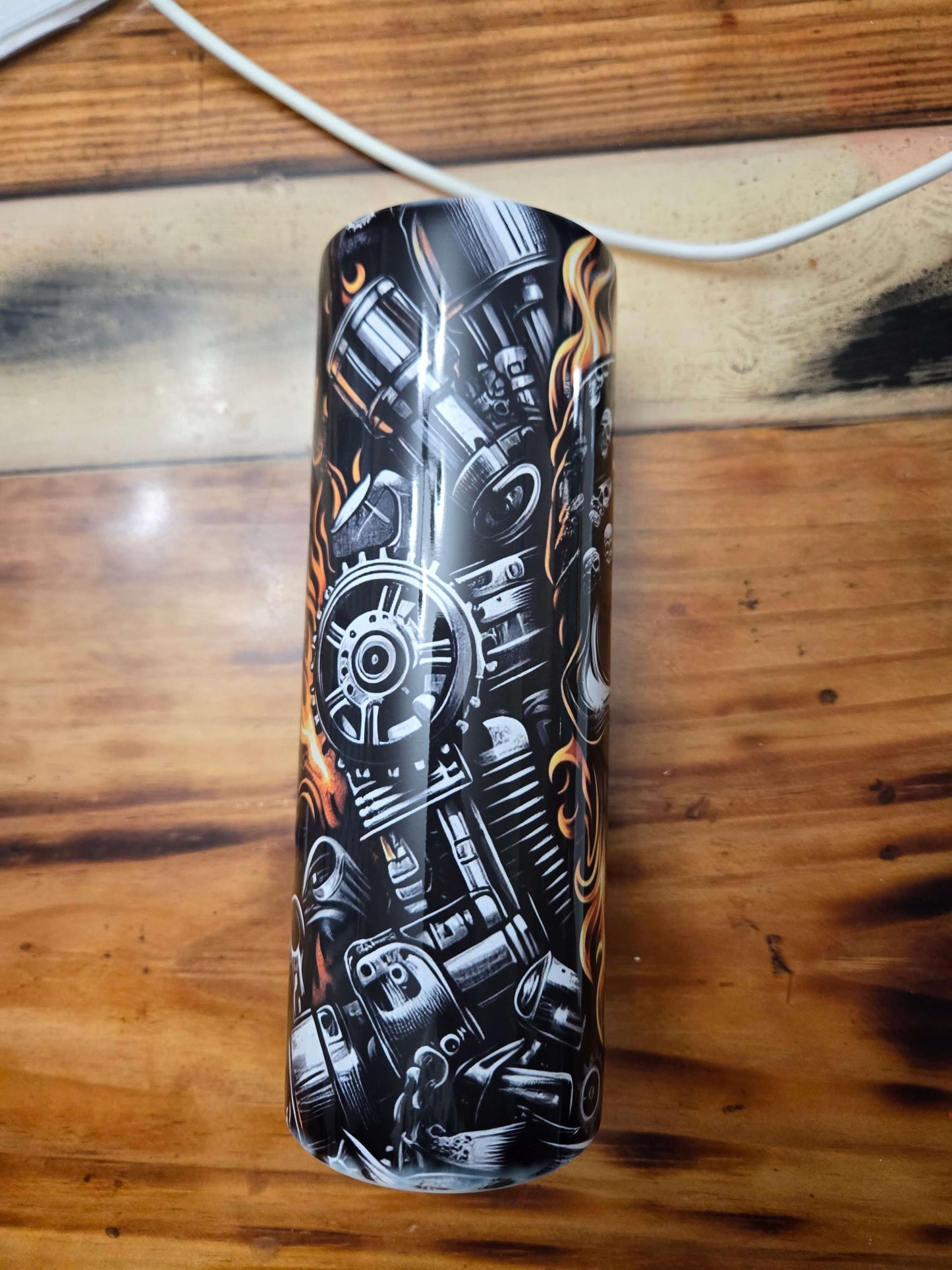 Skull Biker Flames 20oz tumbler cup showing intricate motorcycle engine design with flames, perfect for hot or cold drinks.