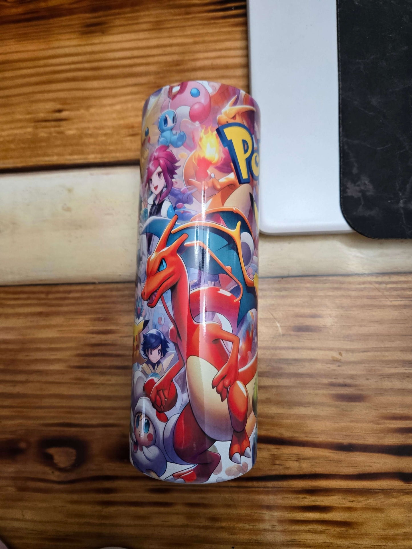 Colorful Pokémon tumbler cup featuring Charizard and various Pokémon characters, perfect for trainers!