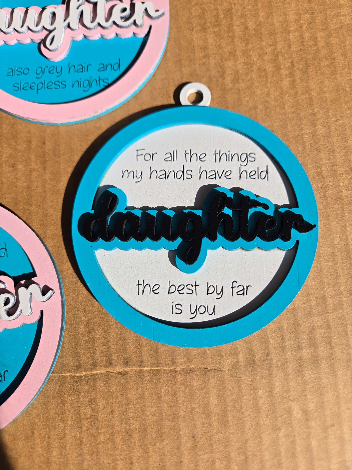 Daughter quoted Christmas ornament with heartfelt message celebrating the bond between parent and child.