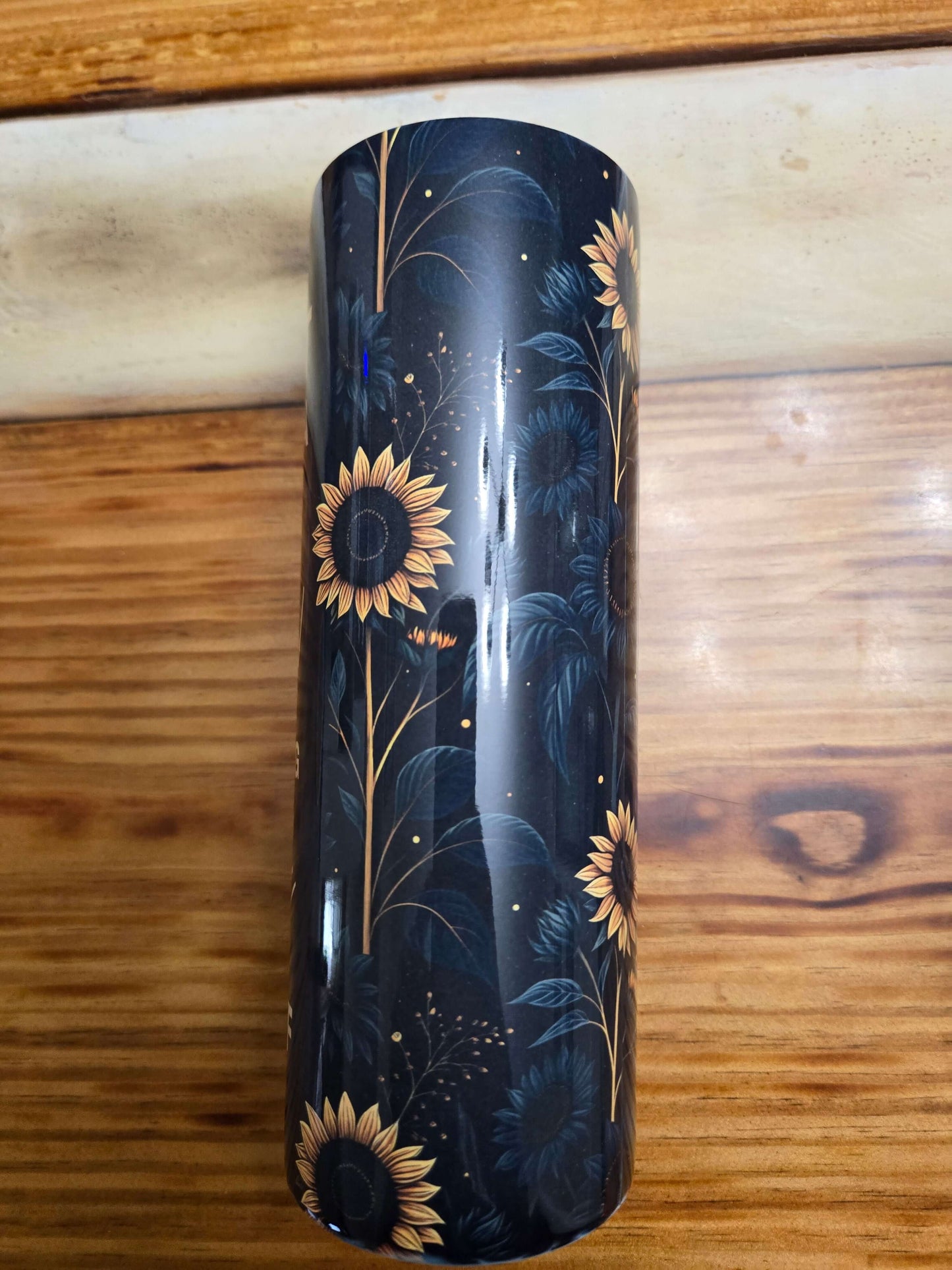 Black tumbler cup with sunflower design, perfect for drinks on the go. Ideal for both hot and cold beverages.