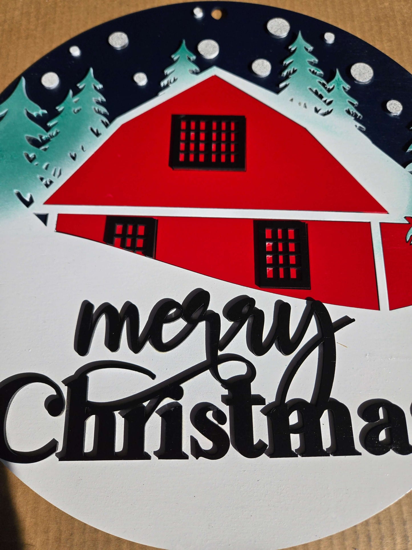 Merry Christmas wooden decor sign featuring a red cabin and snow-covered trees, perfect for holiday decoration.