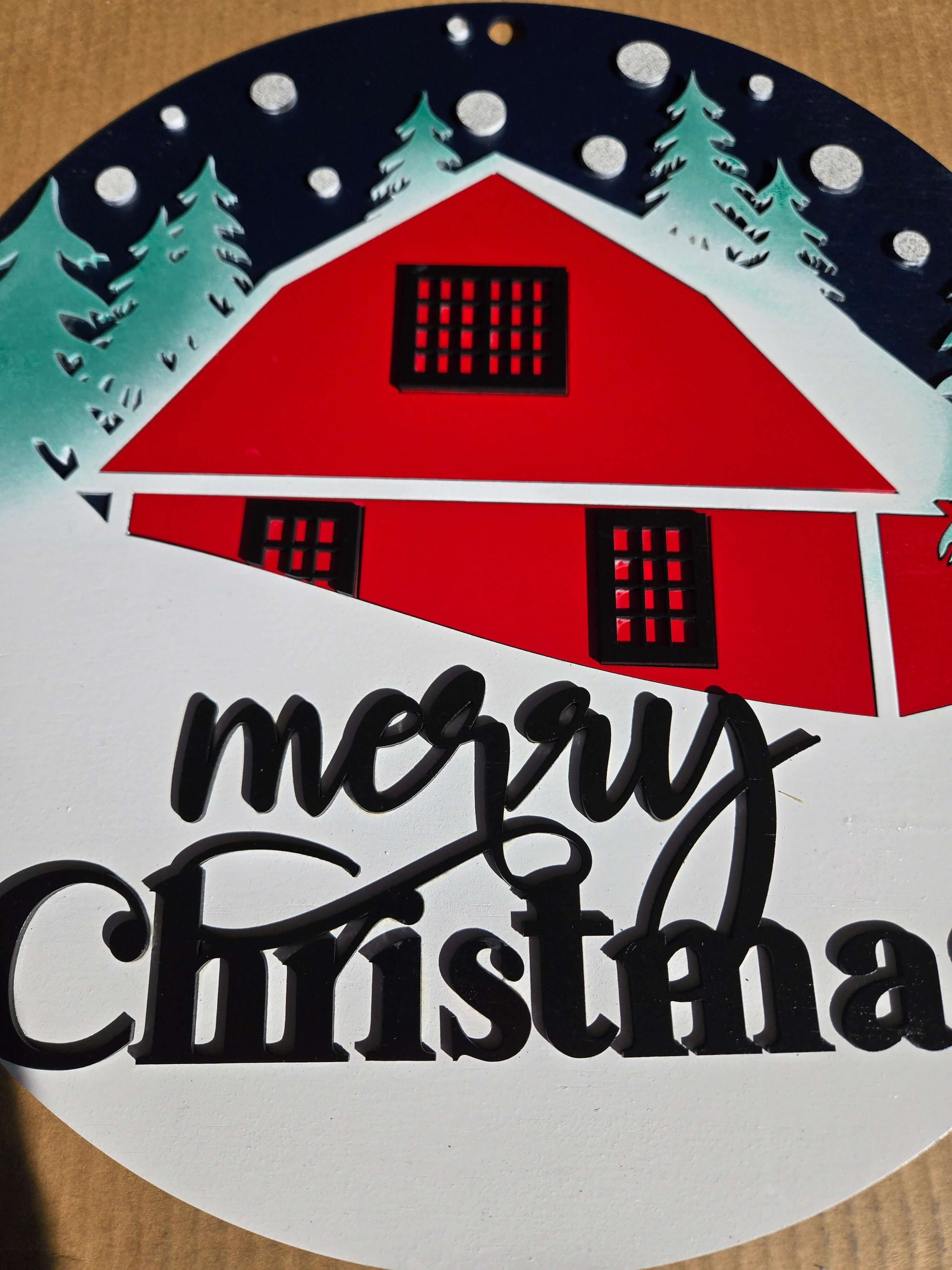 Merry Christmas wooden decor sign featuring a red cabin and snow-covered trees, perfect for holiday decoration.