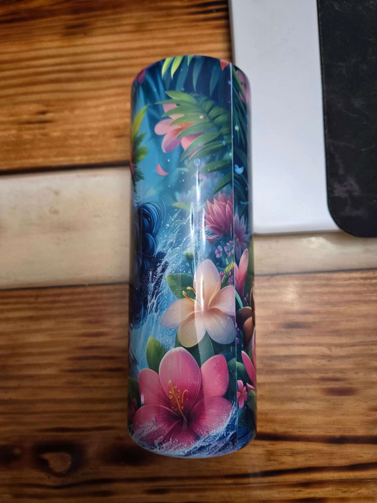 Colorful Moana tumbler cup design featuring tropical flowers and vibrant ocean elements.