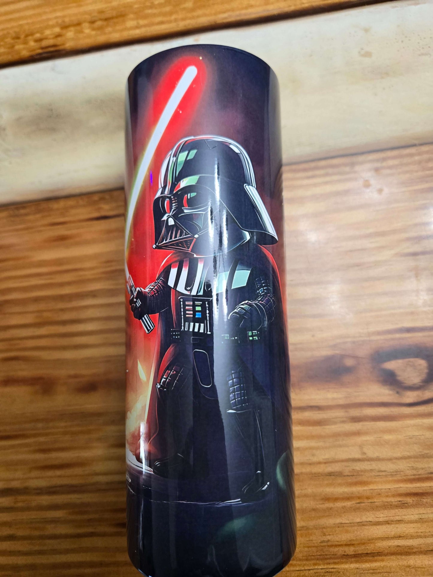 Star Wars 20oz tumbler featuring Darth Vader with a red lightsaber, ideal for hot or cold drinks on the go.