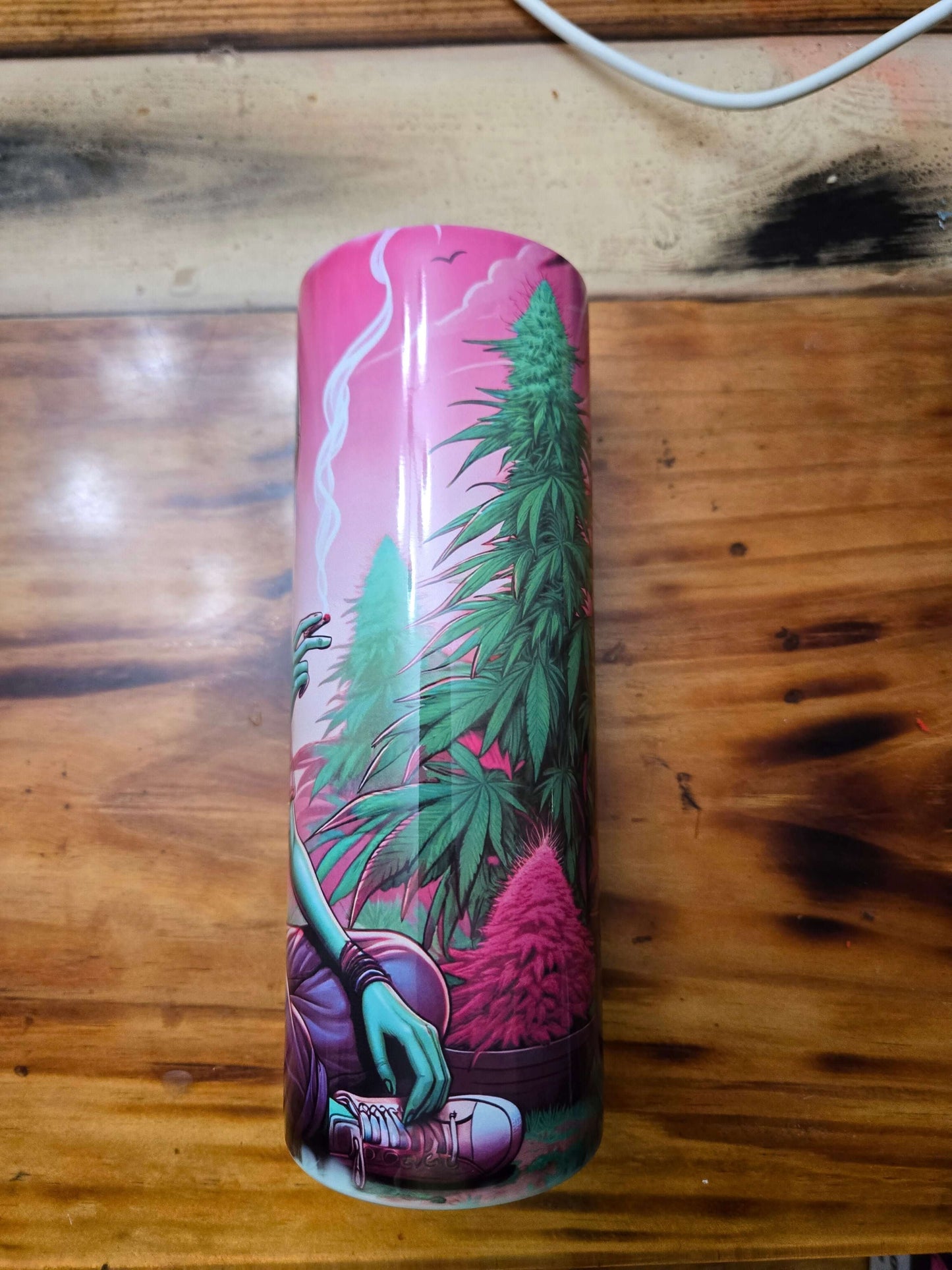 Colorful alien hippie tumbler featuring cannabis plants and vibrant designs, perfect for hot or cold drinks.