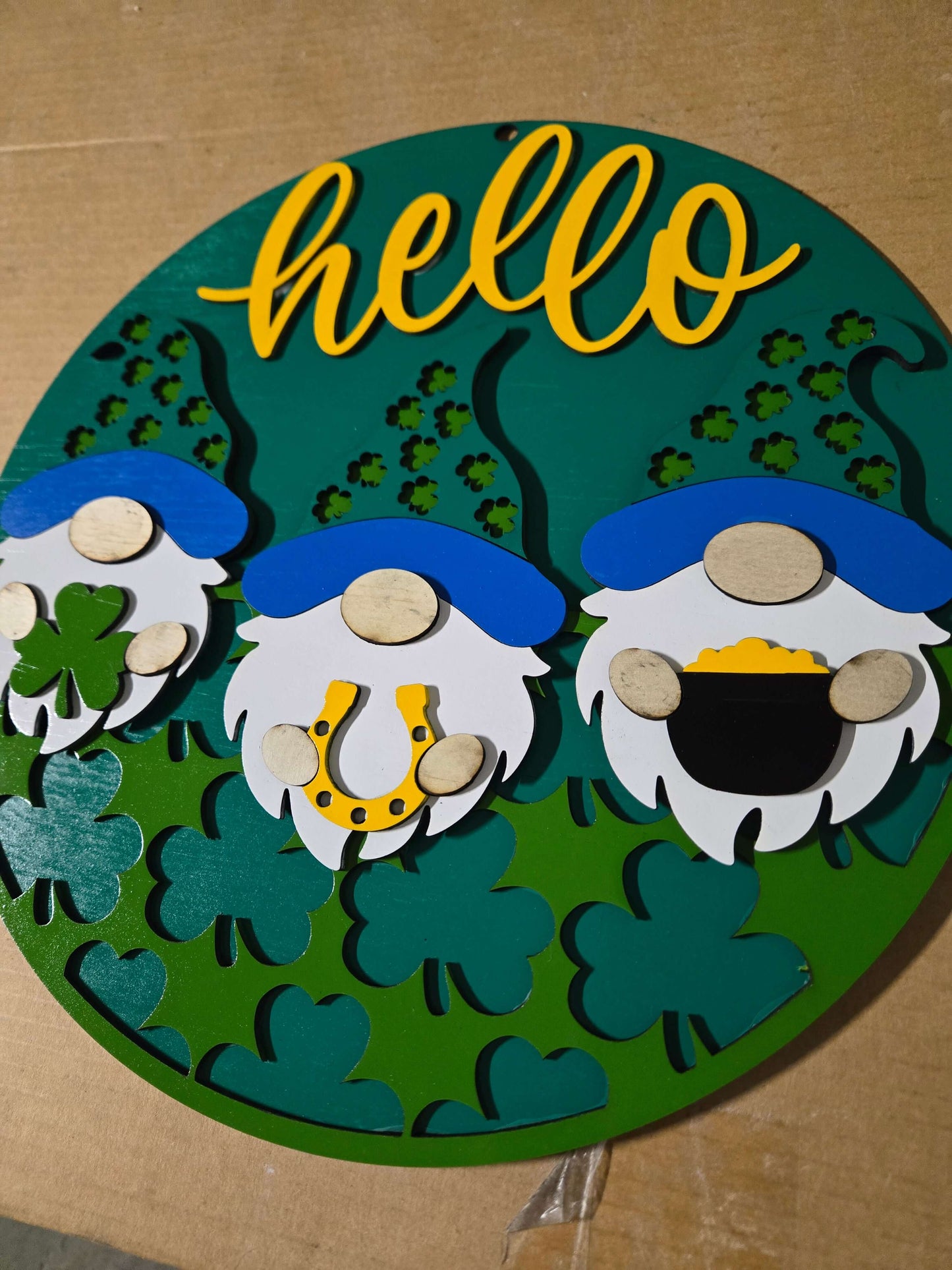 Hello St. Patrick's Day wooden decor sign featuring gnomes and festive elements.