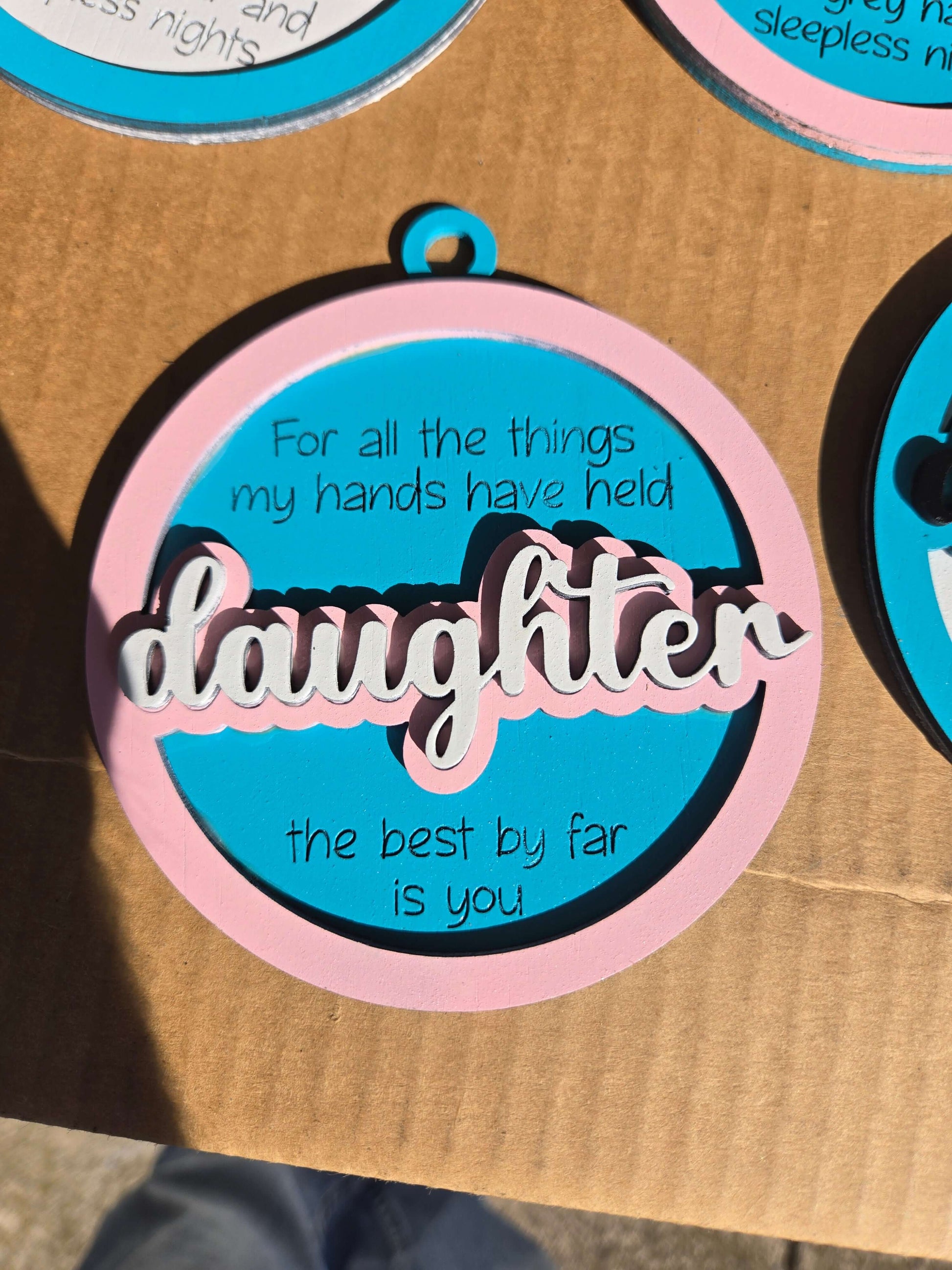 Daughter quoted Christmas ornament with heartfelt message celebrating the bond between parent and child.