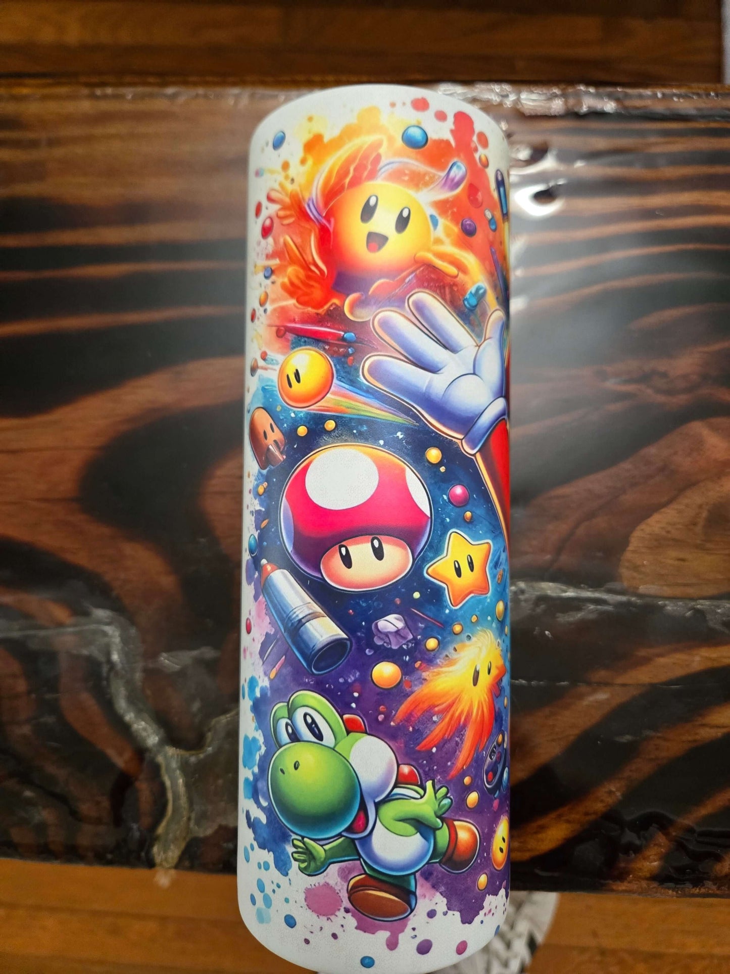 Colorful Mario Brothers 20oz tumbler featuring Yoshi, power-ups, and cartoon characters in vibrant space design.