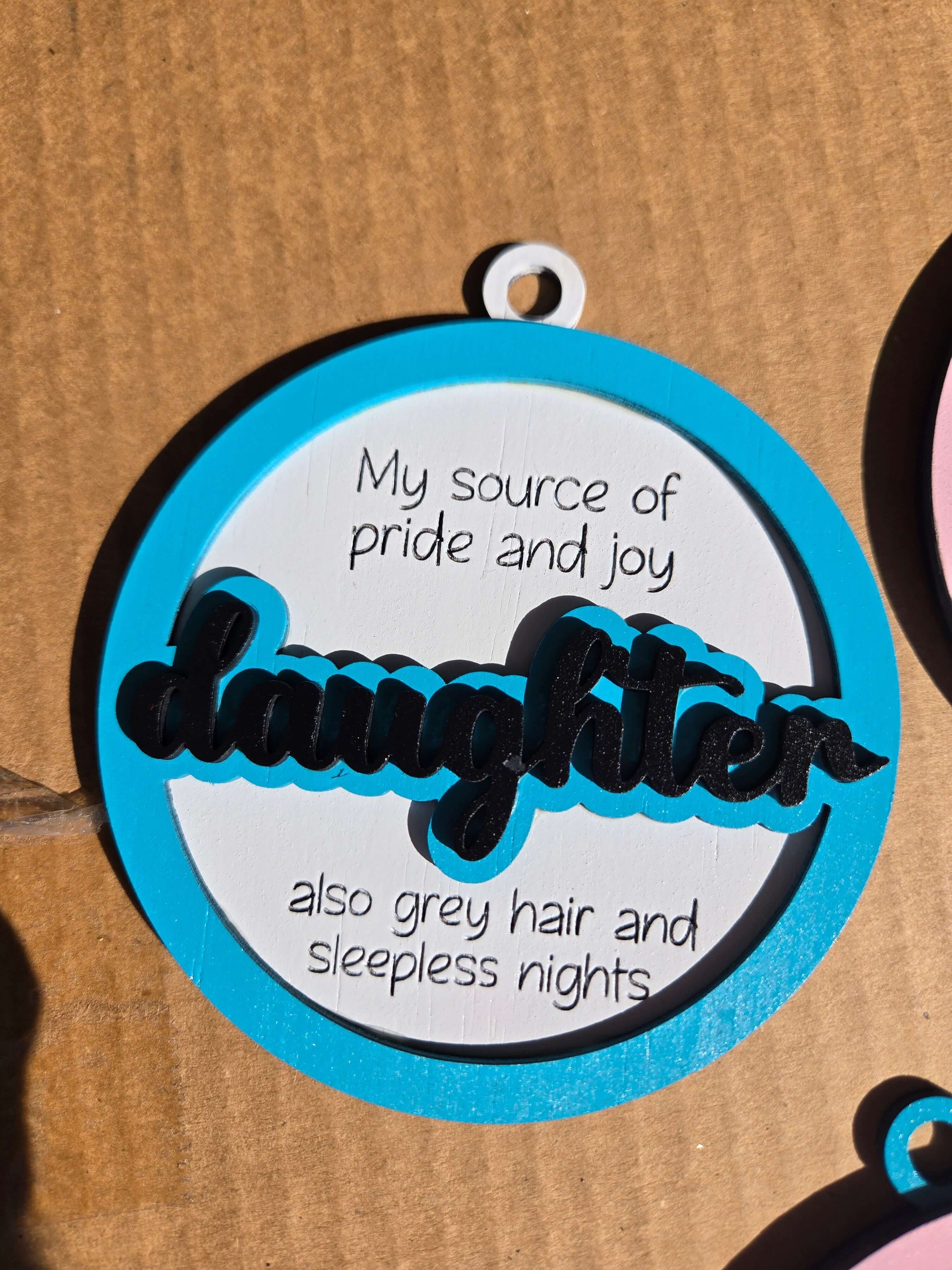 Daughter quoted Christmas ornament with heartfelt message about pride, joy, and sleepless nights.
