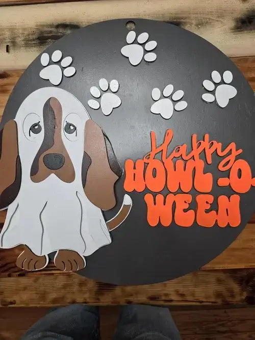 Happy Halloween sign featuring a basset hound in a ghost costume with paw prints.