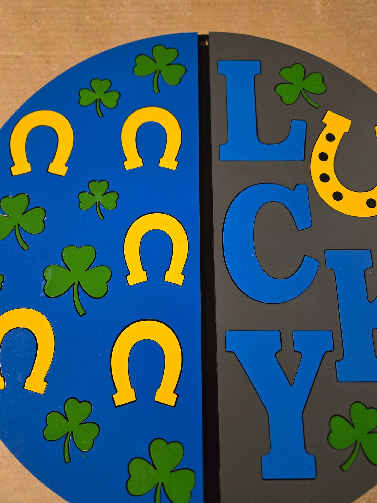 Lucky St. Patrick's Day wooden sign with colorful horseshoes and shamrocks, perfect for festive home decor.