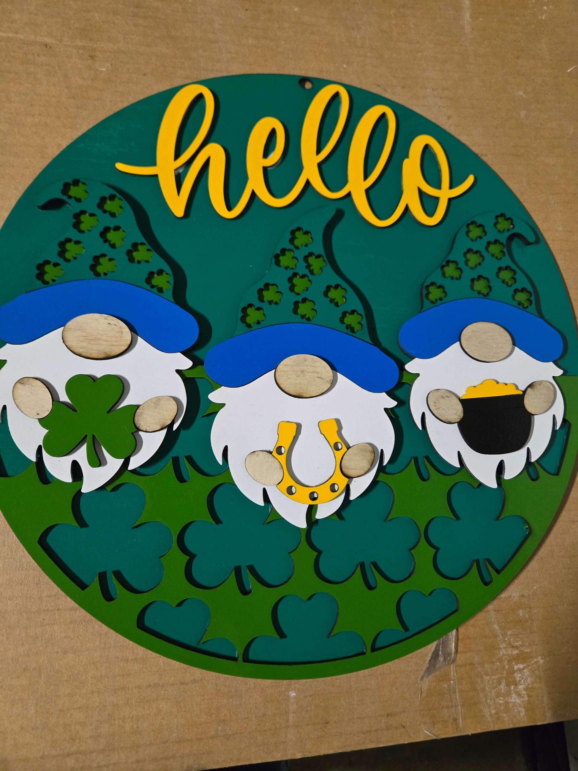 Hello St. Patrick's Day wooden decor sign featuring three gnomes and green clovers, perfect for festive home decor.