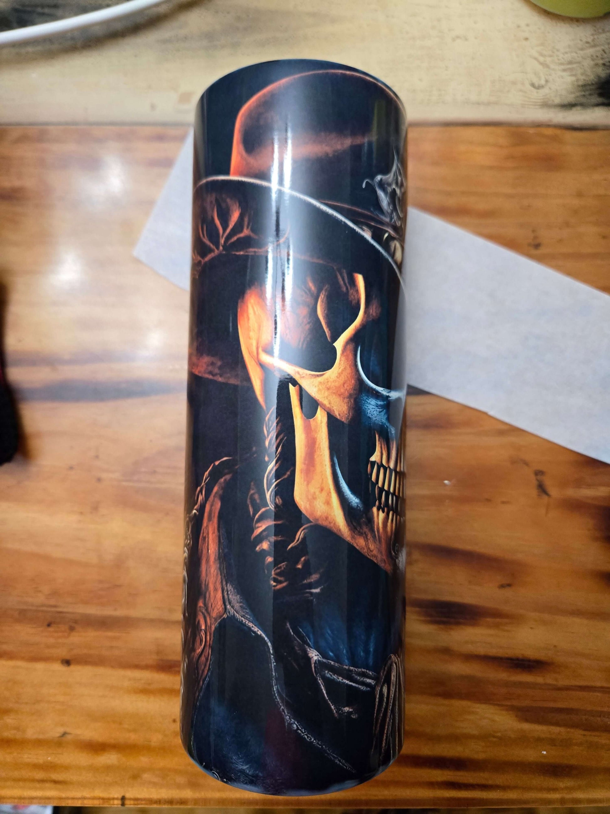 Skull cowboy design tumbler cup showcasing intricate details, perfect for hot and cold beverages on the go.