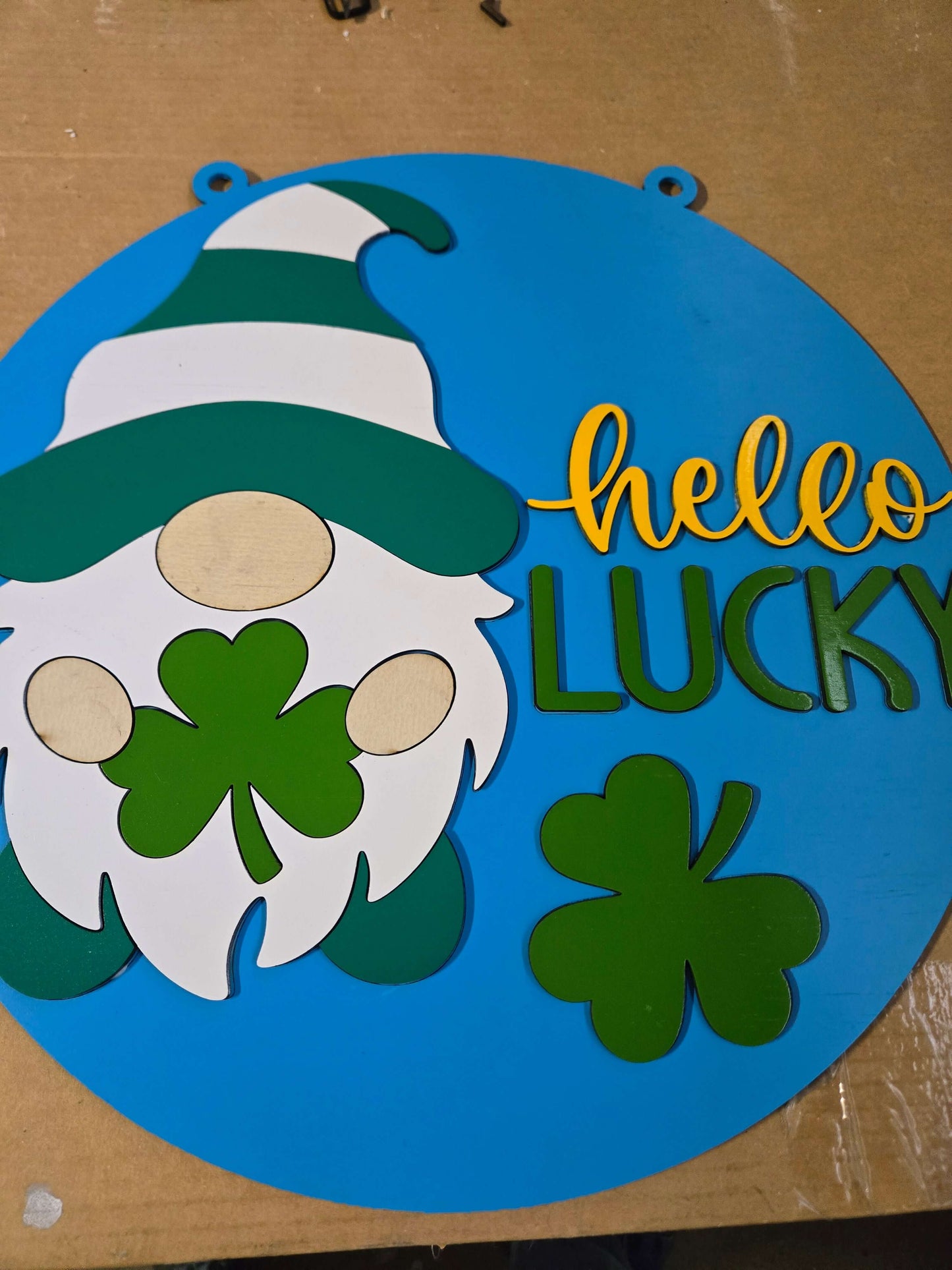 Hello lucky St. Patrick's Day gnome wooden sign with clovers and cheerful colors.