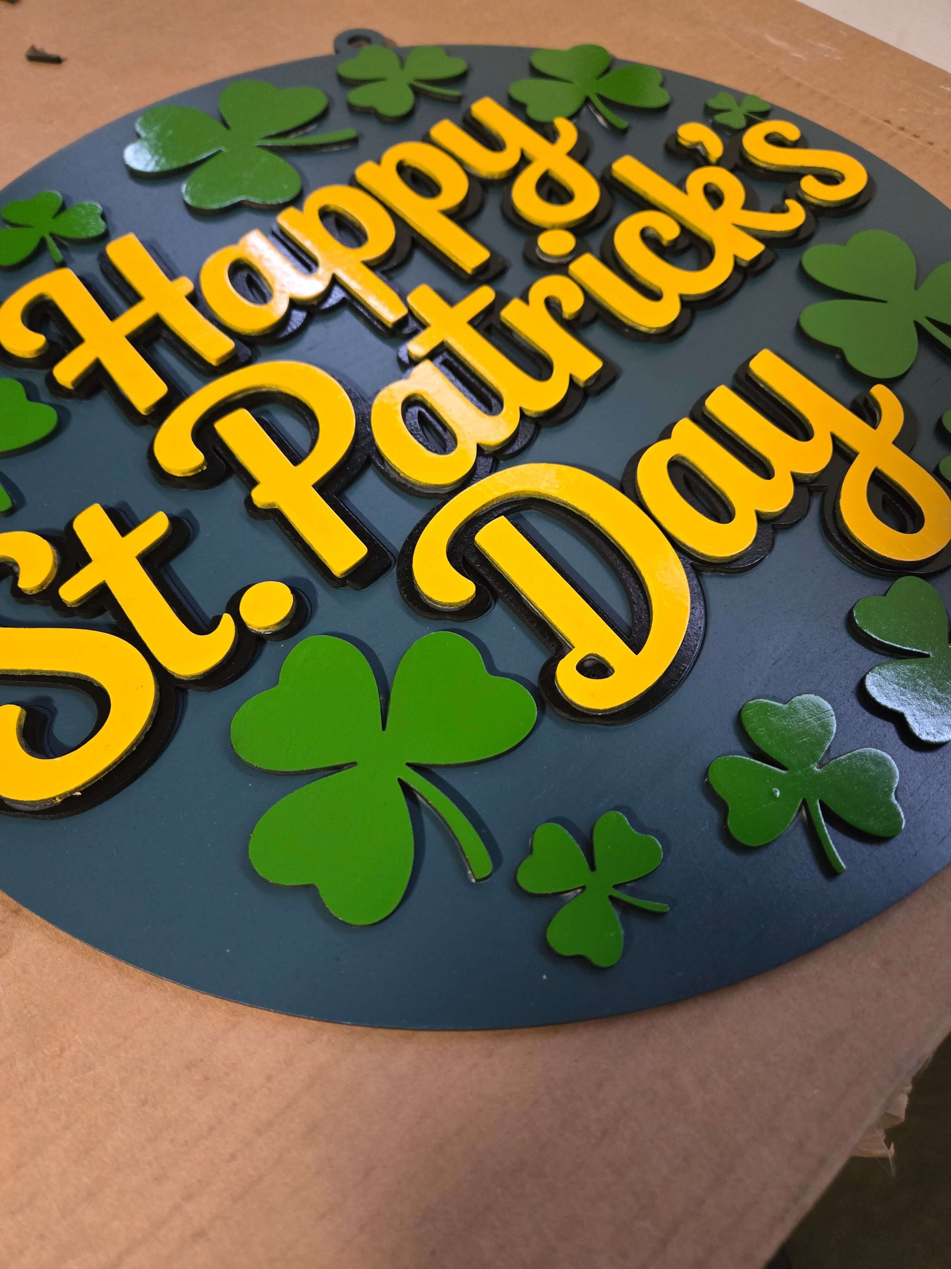 Happy St. Patrick's Day wooden sign featuring vibrant yellow lettering and green shamrocks.