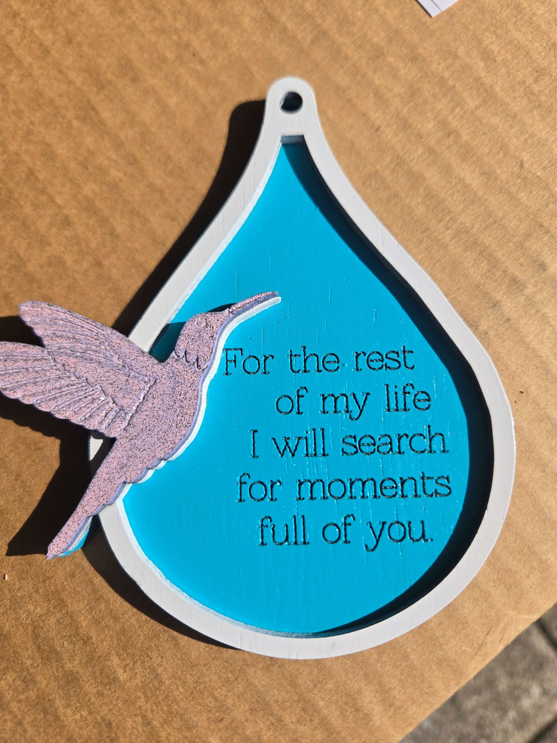 Humming bird ornament featuring a heartfelt quote on a teardrop shape, perfect for holiday decor.