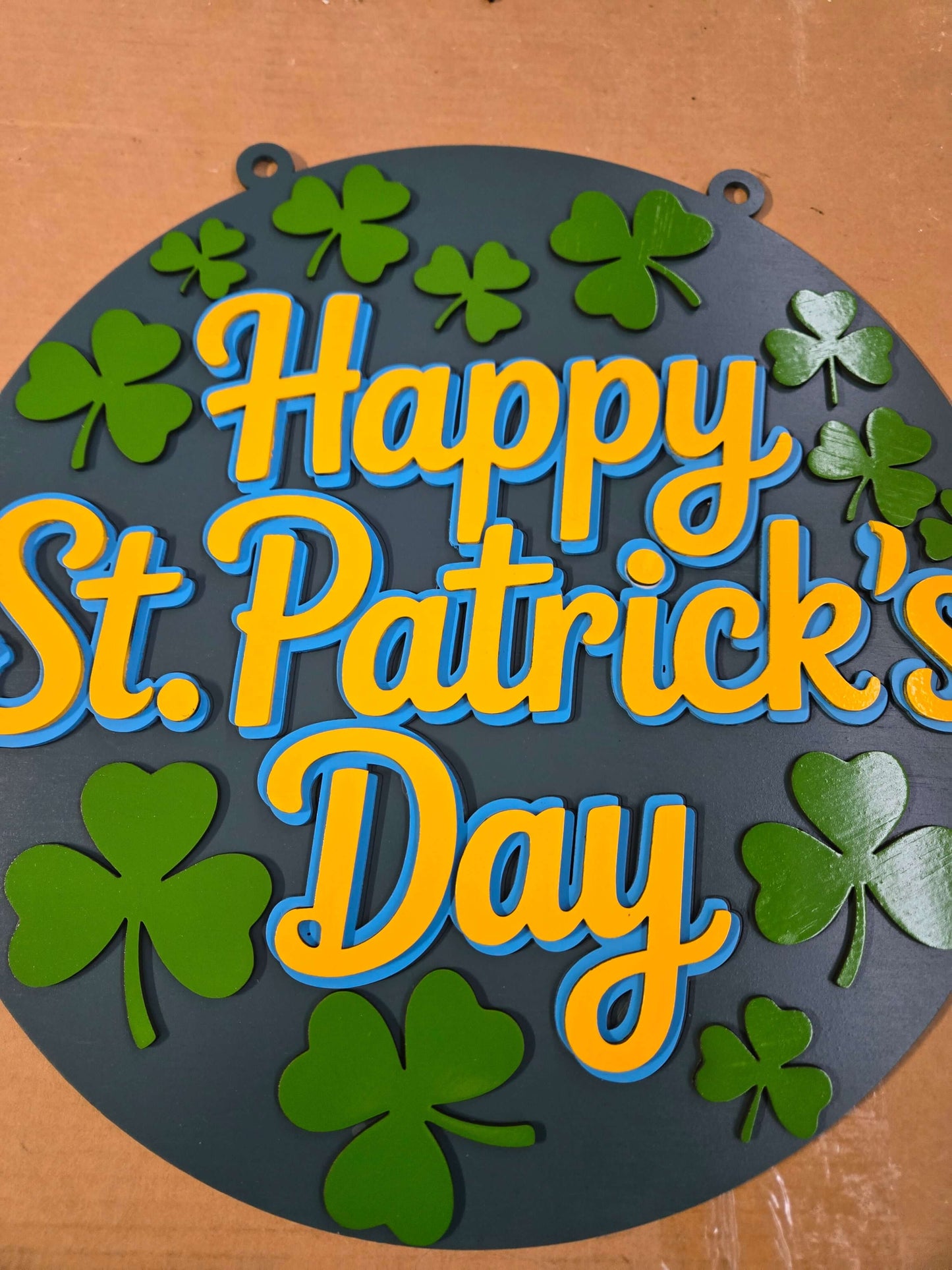 Happy St. Patrick's Day wooden decor sign with vibrant colors and shamrock designs.