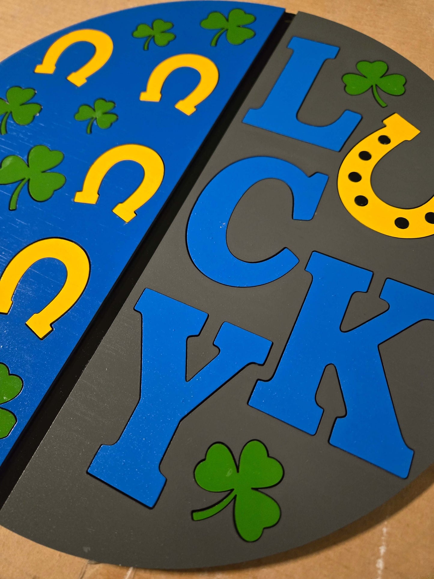 Lucky St. Patrick's Day wooden decor sign with vibrant colors and playful designs of clovers and horseshoes.