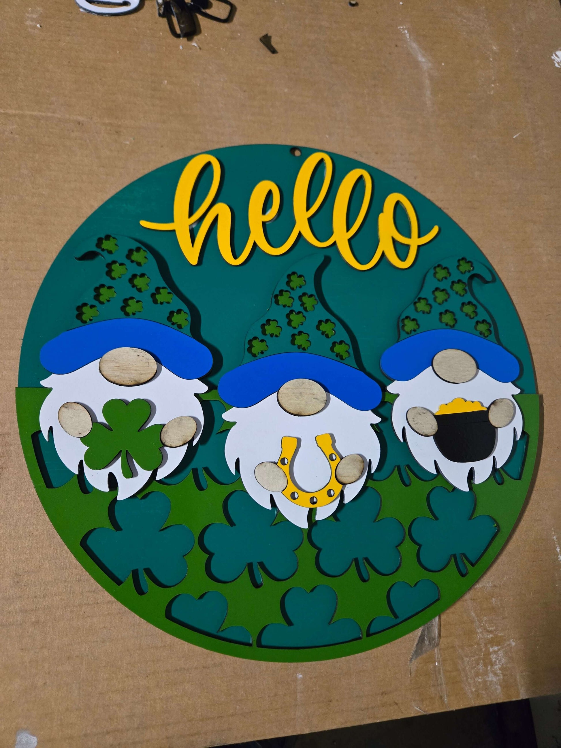 Hello St. Patrick's Day wooden decor sign featuring gnomes and green clovers.