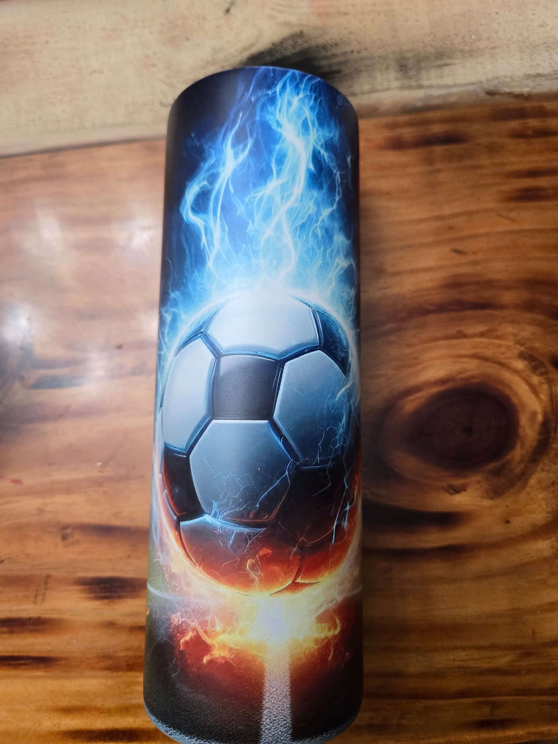 Soccer tumbler cup featuring a dynamic design with a fiery soccer ball and electric blue accents.