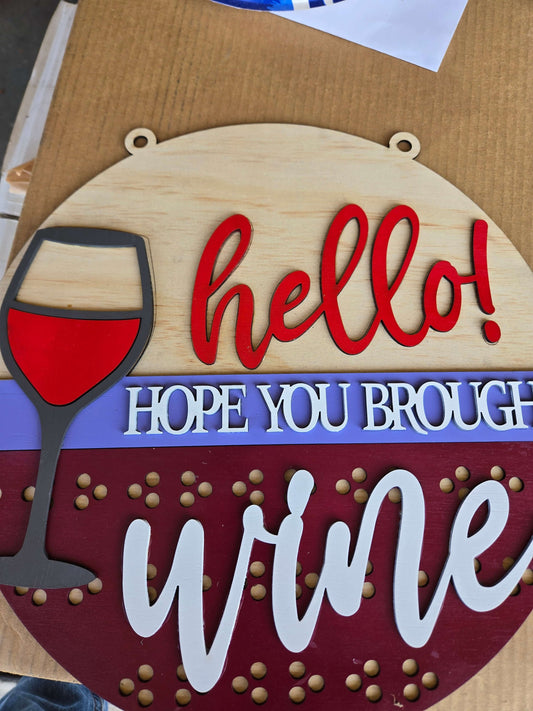 Hope you brought wine wooden sign featuring a wine glass and the word hello, ideal for home decor.