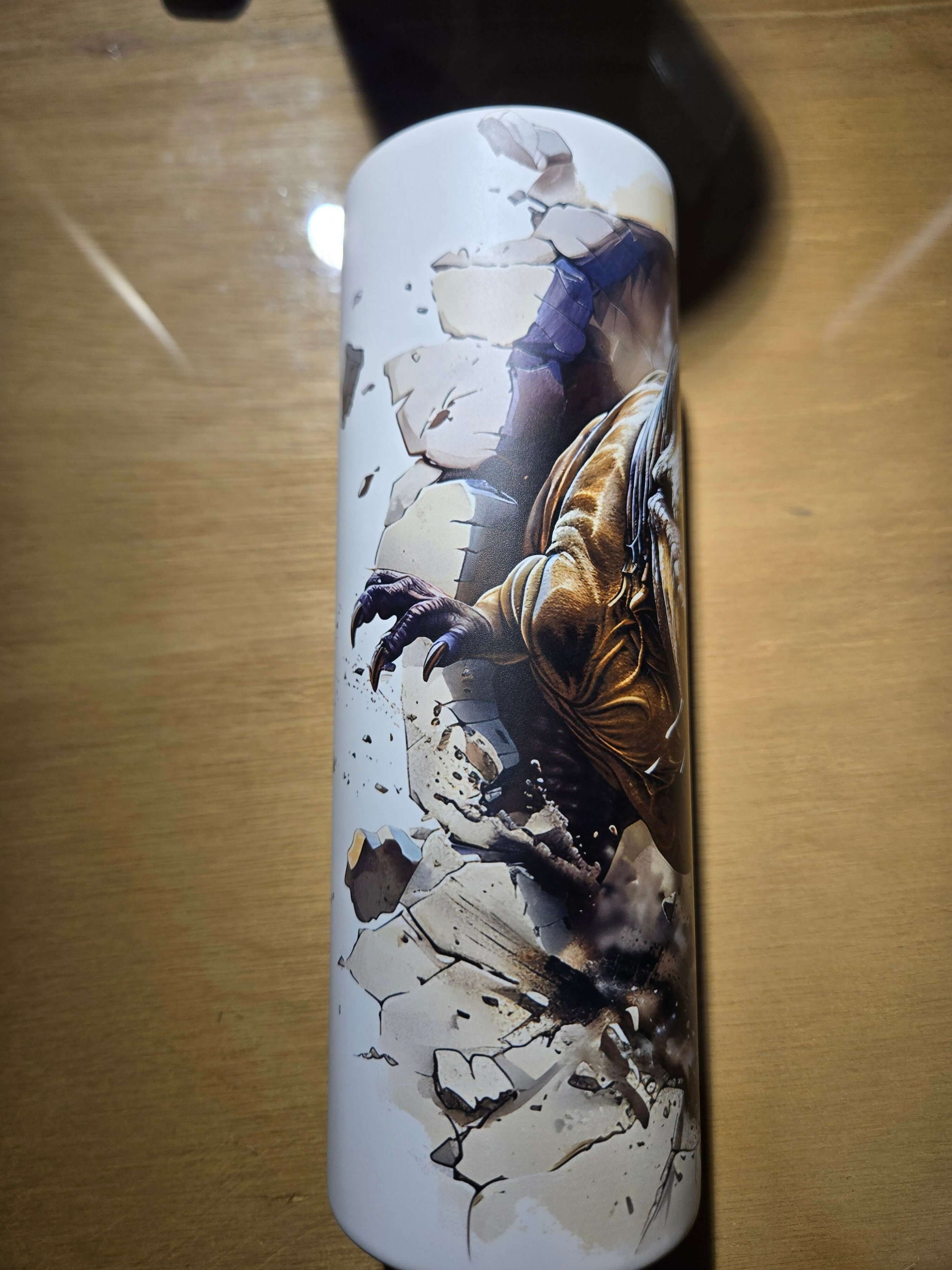 T Rex glow in the dark tumbler cup featuring dynamic dinosaur design breaking through a cracked surface.