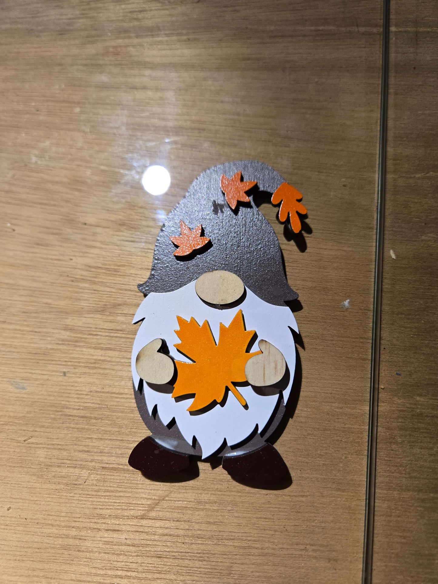 Small ghost and gnomes magnets holiday decor with colorful autumn leaves in detail.