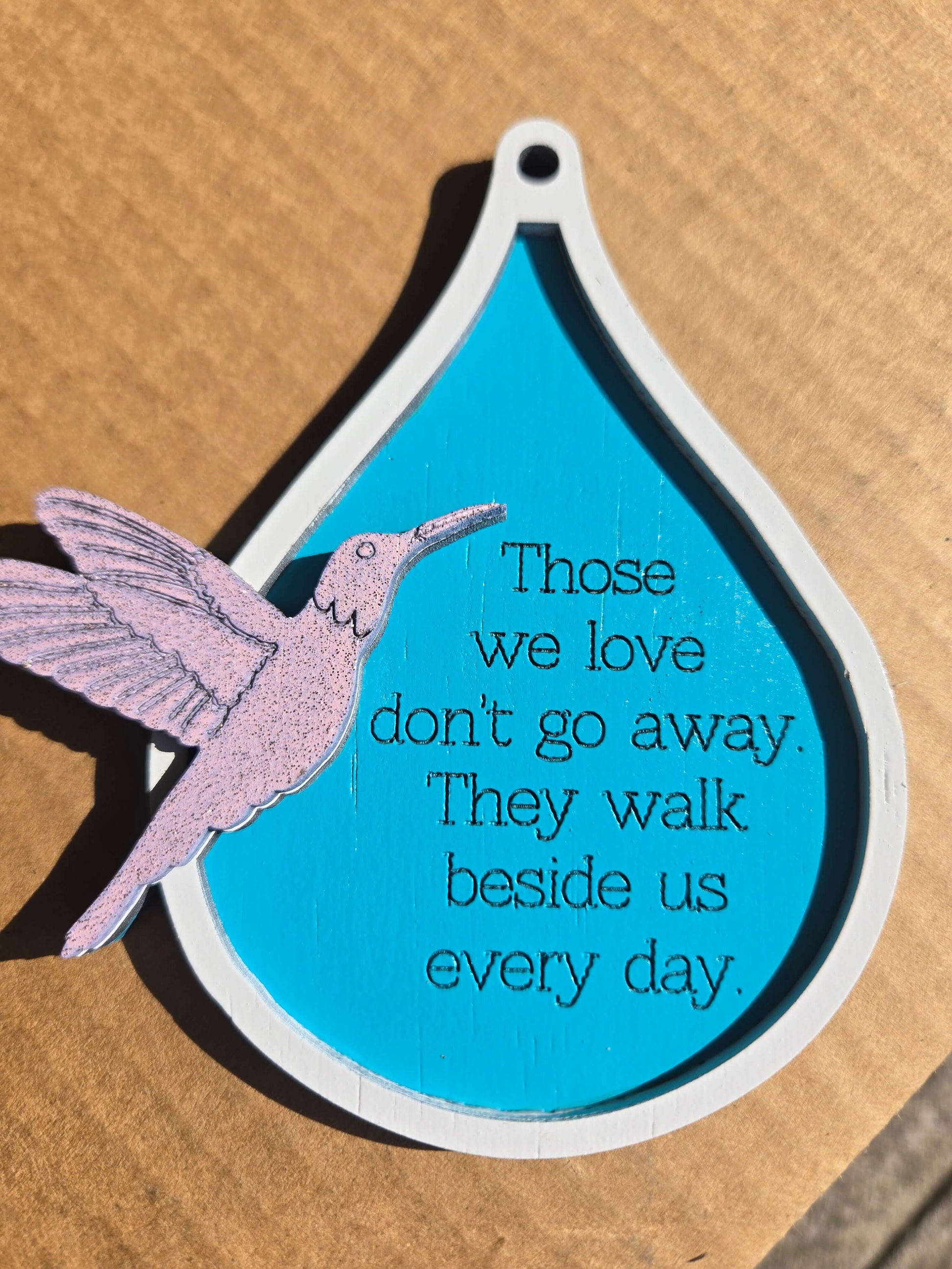 Humming bird ornament with a quote about love and memory, vibrant holiday decor for Christmas.