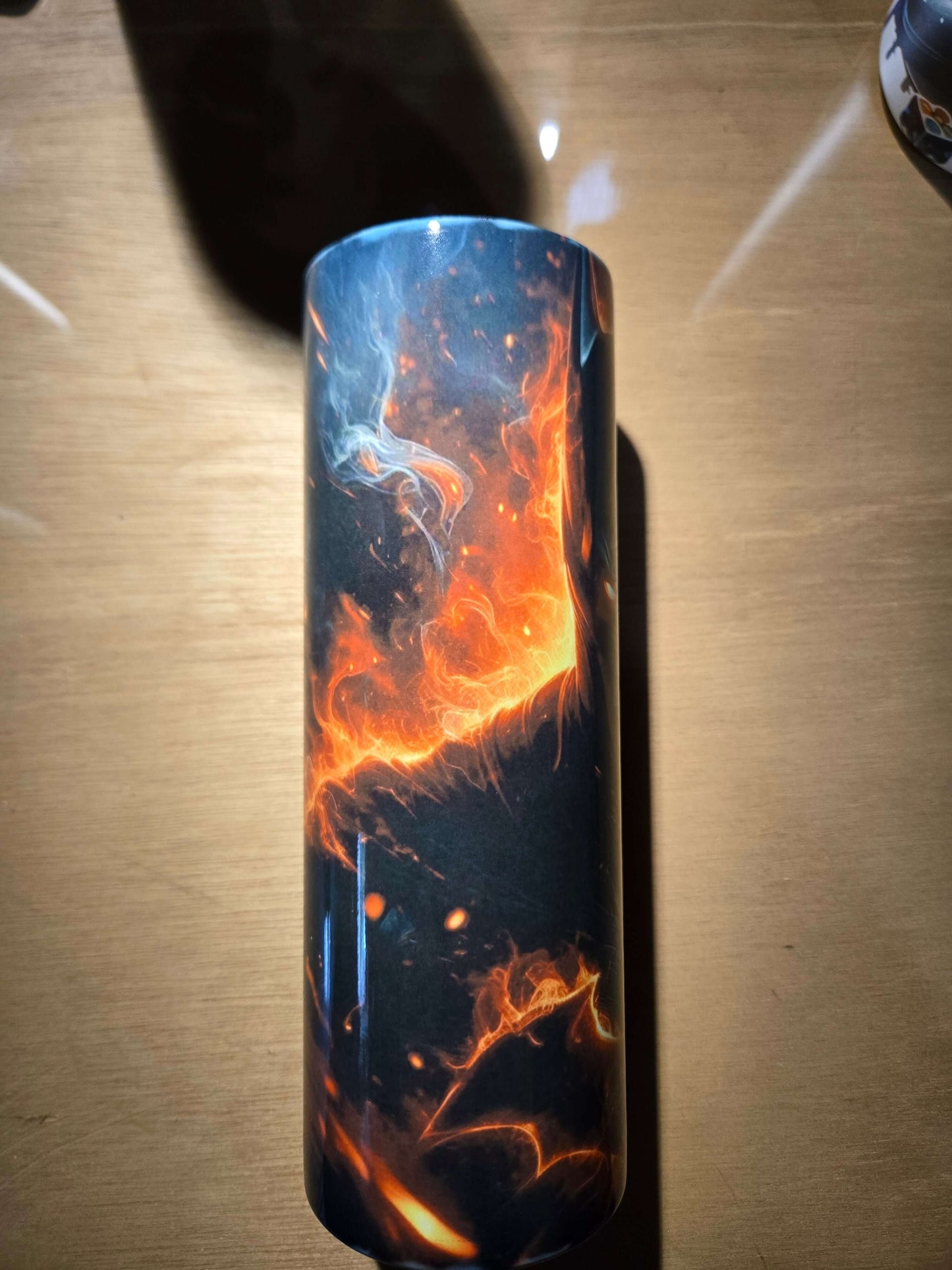 Batman 20oz tumbler cup featuring a striking design with fire and smoke elements on a sleek black surface.