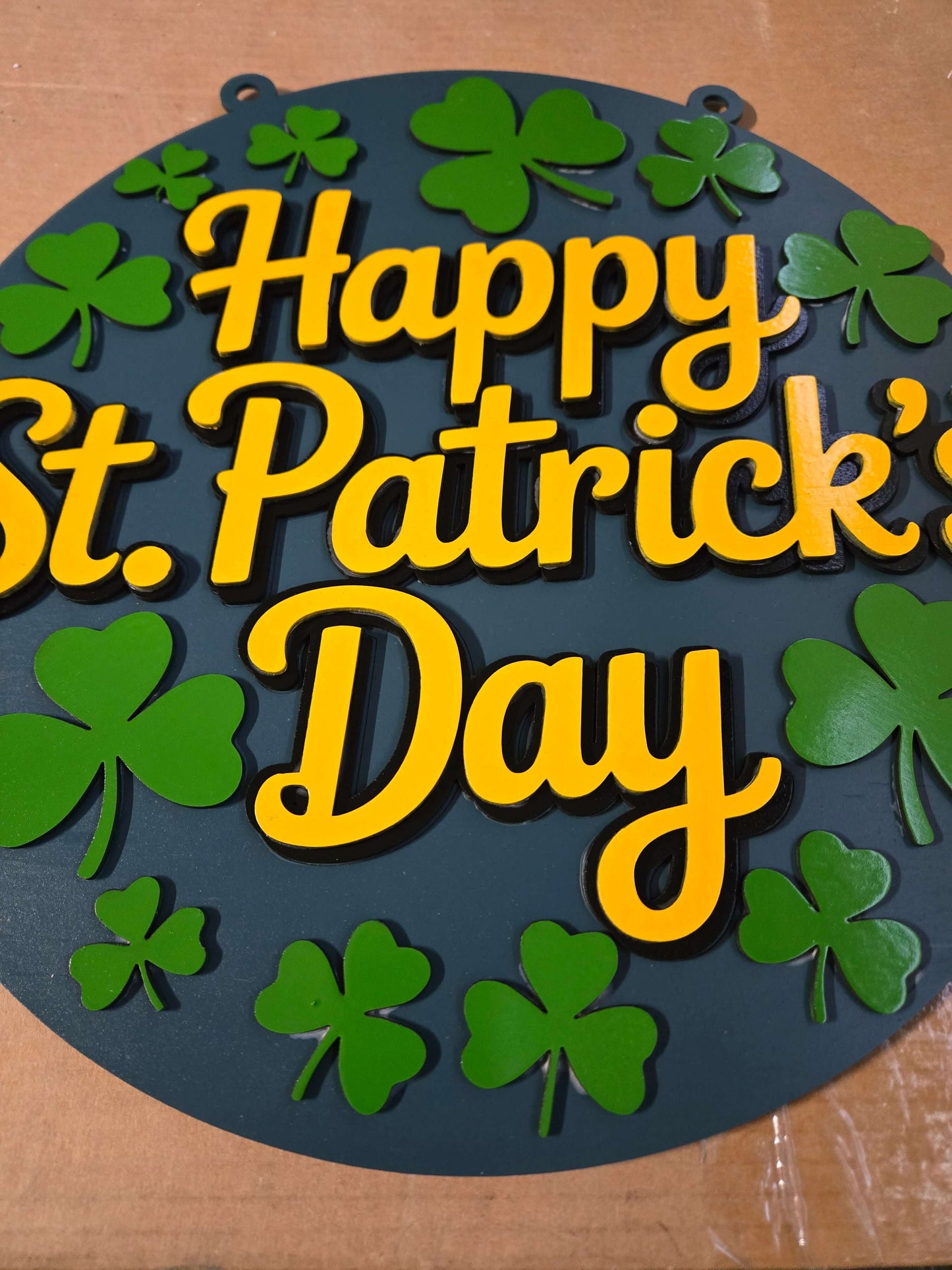 Happy St. Patrick's Day wooden decor sign with green clovers and hand-painted details.