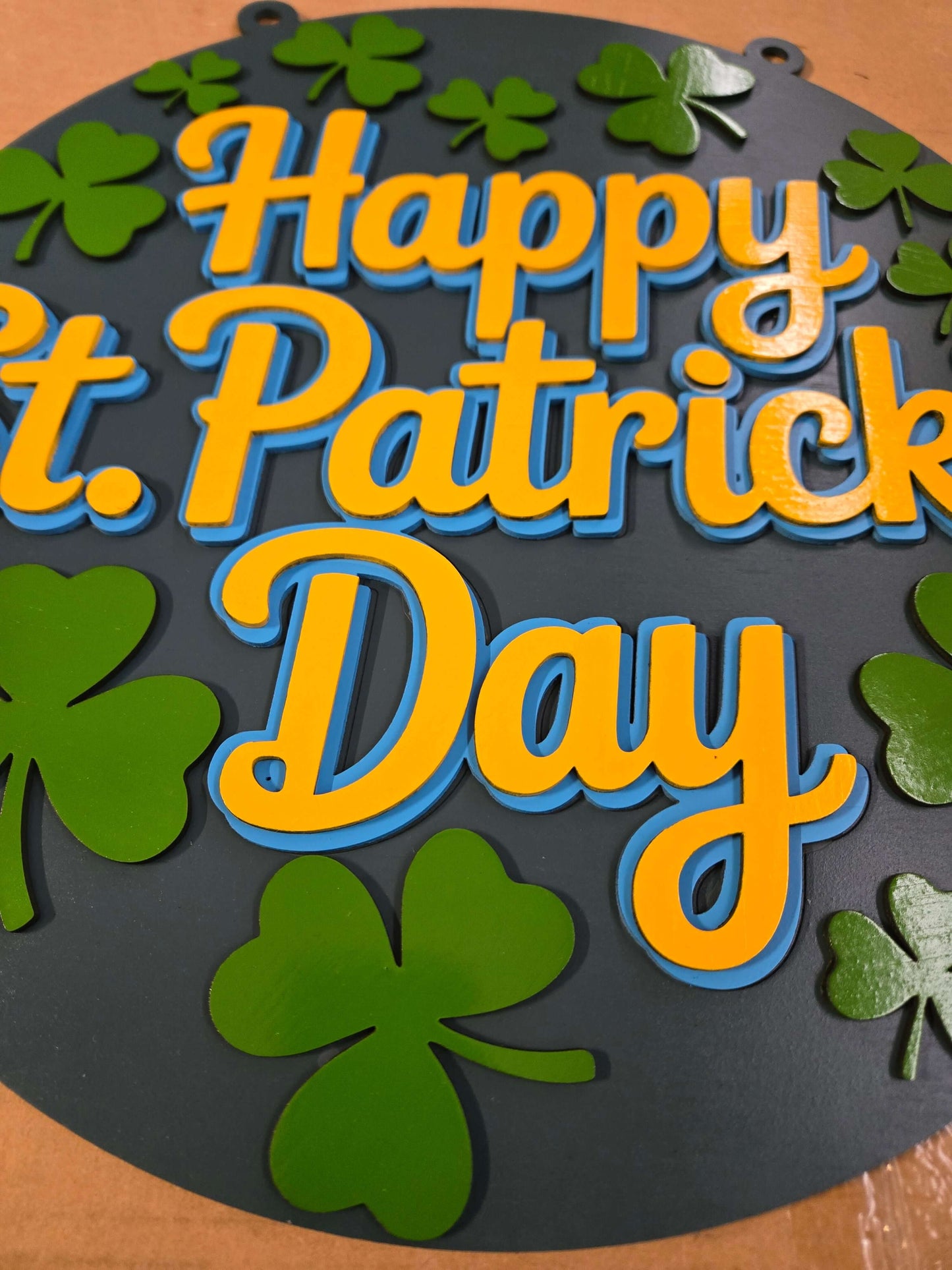 Happy St. Patrick's Day wooden decor sign with vibrant colors and shamrock designs.