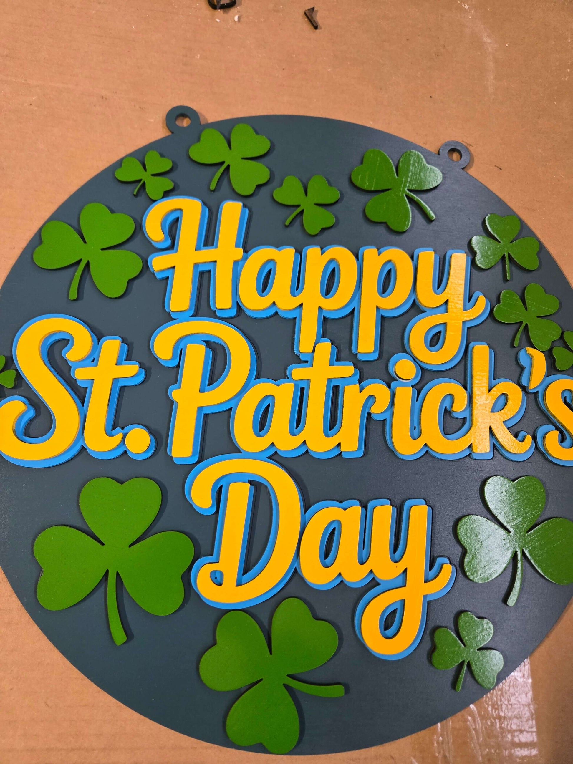 Happy St. Patrick's Day wooden decor sign with vibrant colors and shamrock designs.