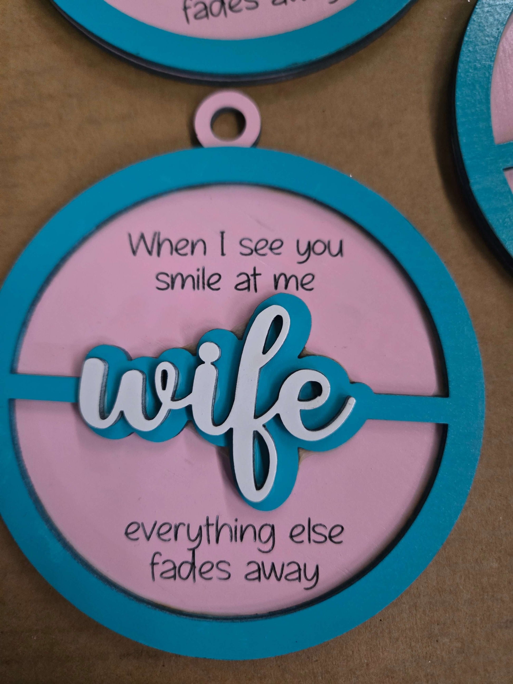Wooden Christmas ornament with the word 'wife' and the quote about love and devotion.