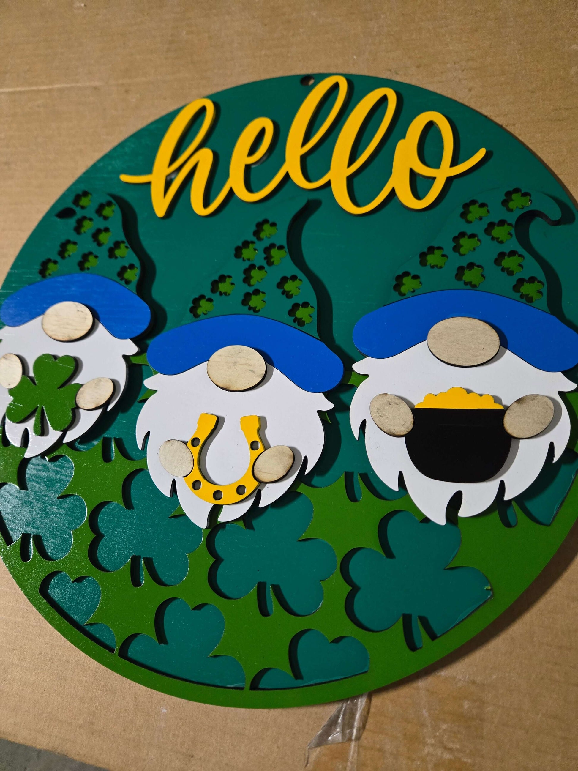 Hello St. Patrick's Day wooden decor sign featuring gnomes and festive elements.